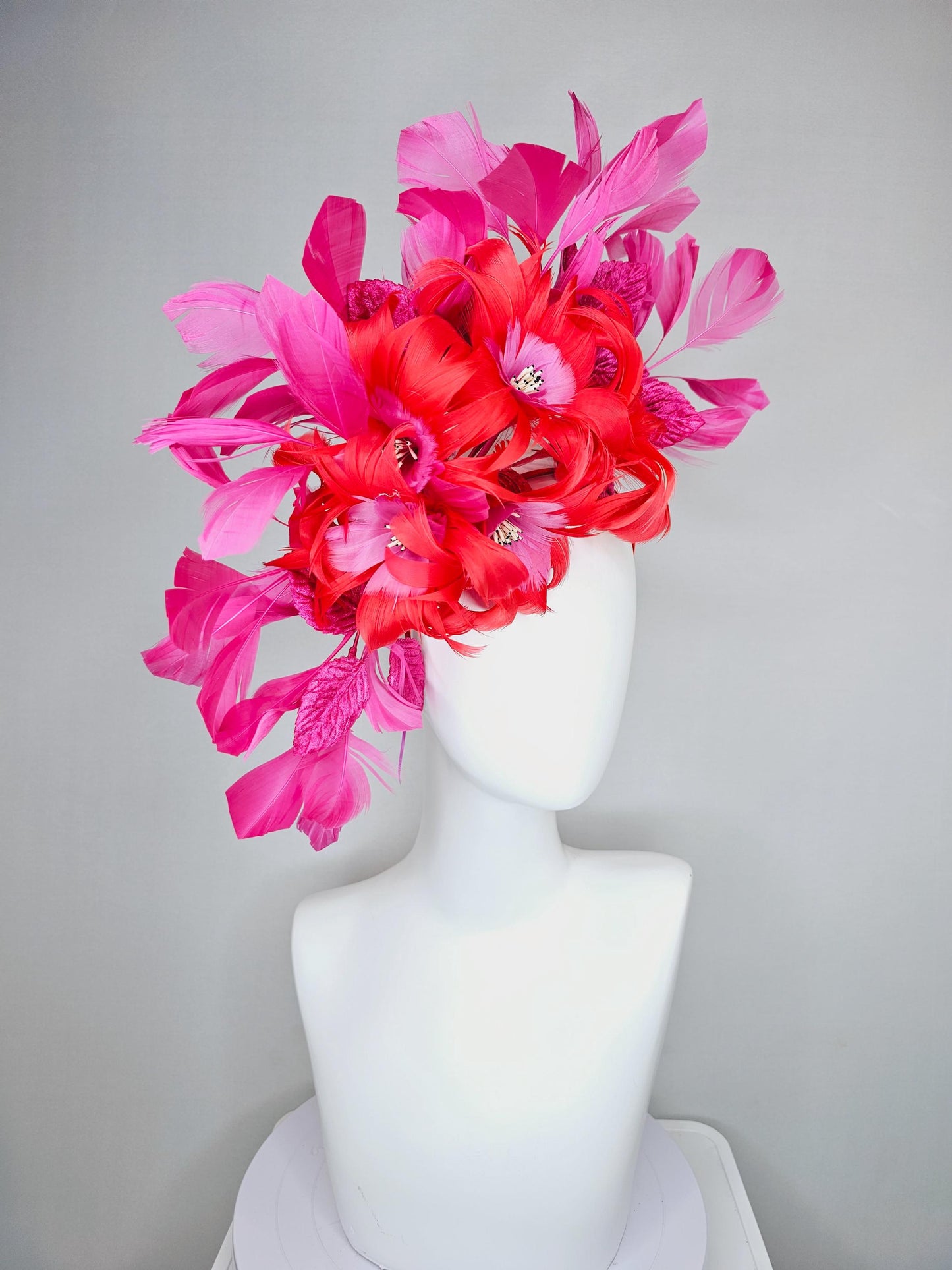 kentucky derby hat fascinator with cherry red feather flowers with blush pink feather cores, pink leaves and pink branching feathers