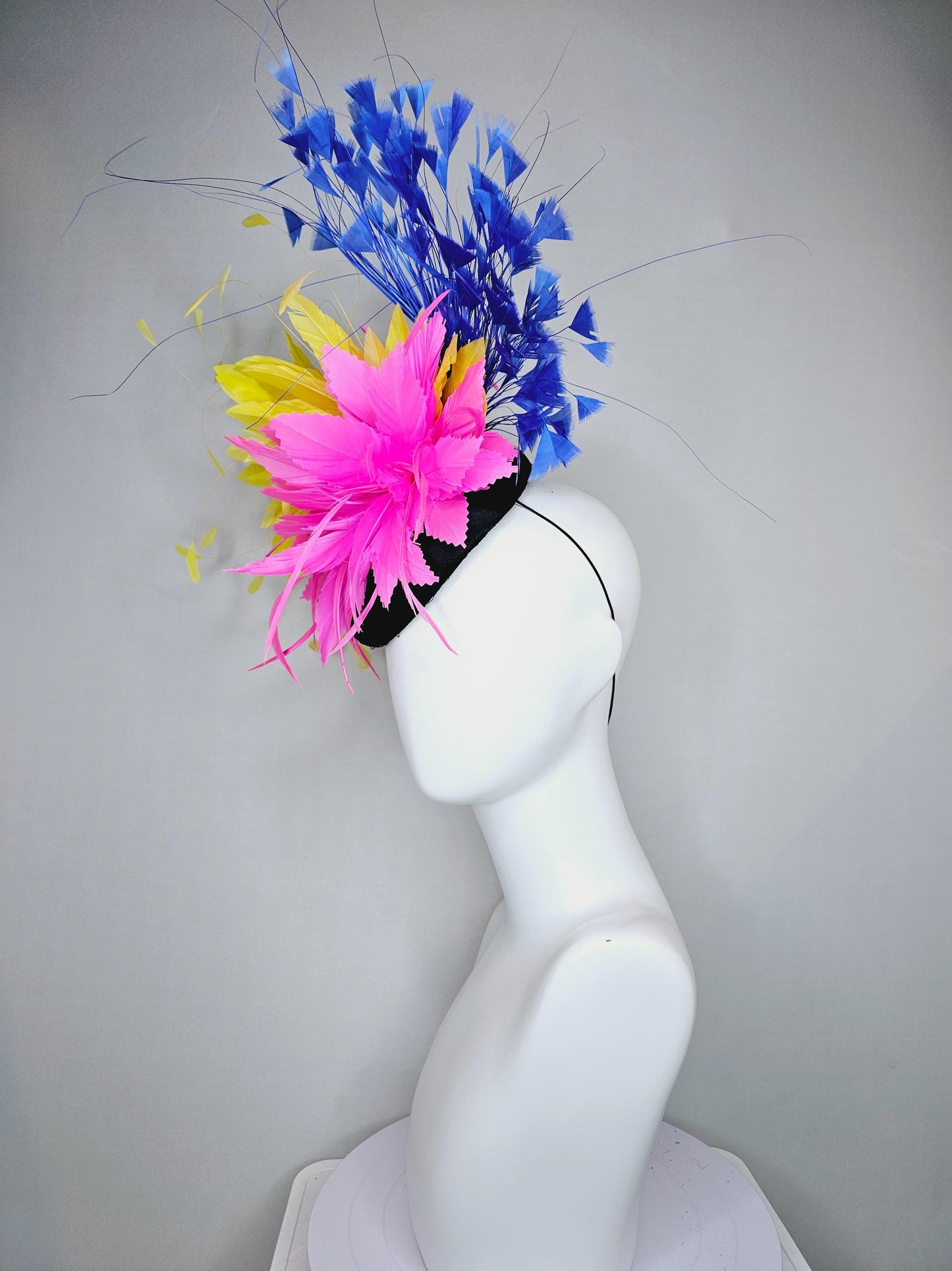 kentucky derby hat fascinator black satin with netting, pink and yellow feather flower, cobalt royal blue branching feathers