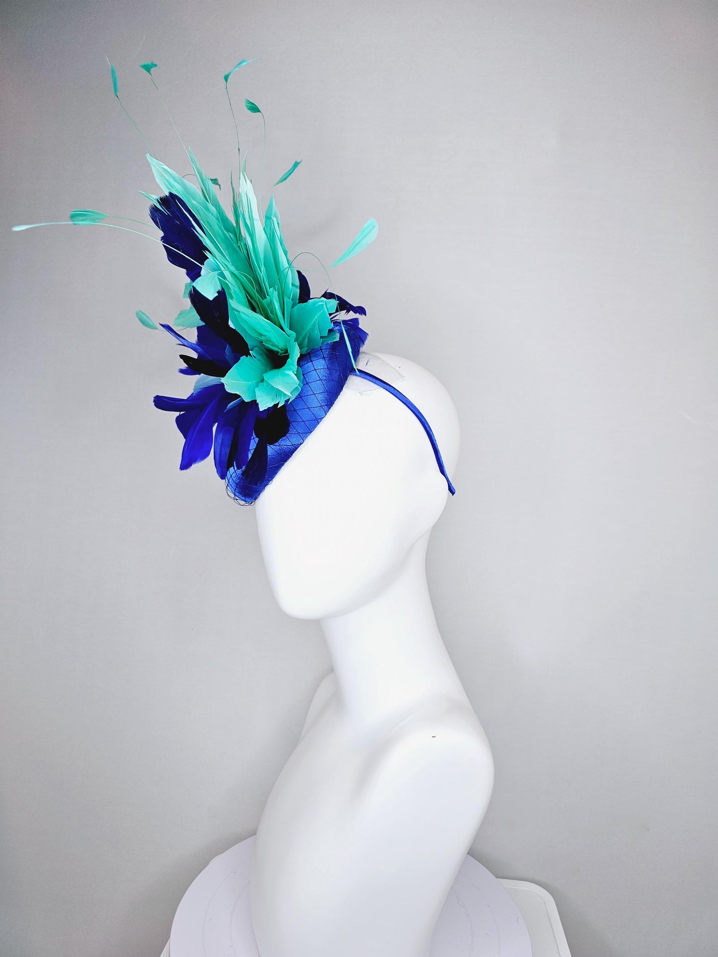 kentucky derby hat fascinator cobalt blue satin with netting and fluffy cobalt blue, light blue,navy blue,aqua blue green branching feathers