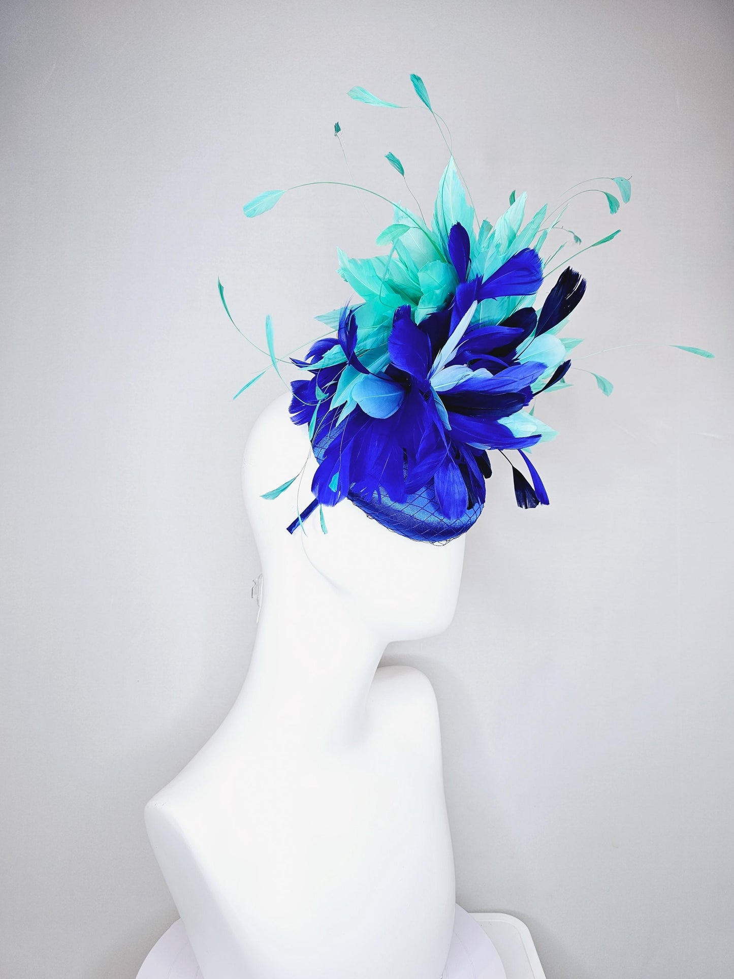 kentucky derby hat fascinator cobalt blue satin with netting and fluffy cobalt blue, light blue,navy blue,aqua blue green branching feathers