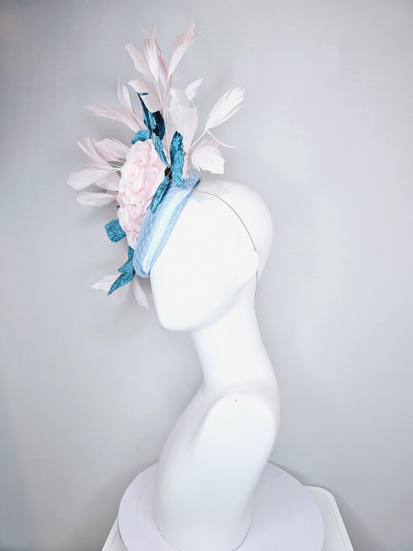 kentucky derby hat fascinator light blue satin with netting, light pink satin rose flowers, blue leaves, light pink branching feathers