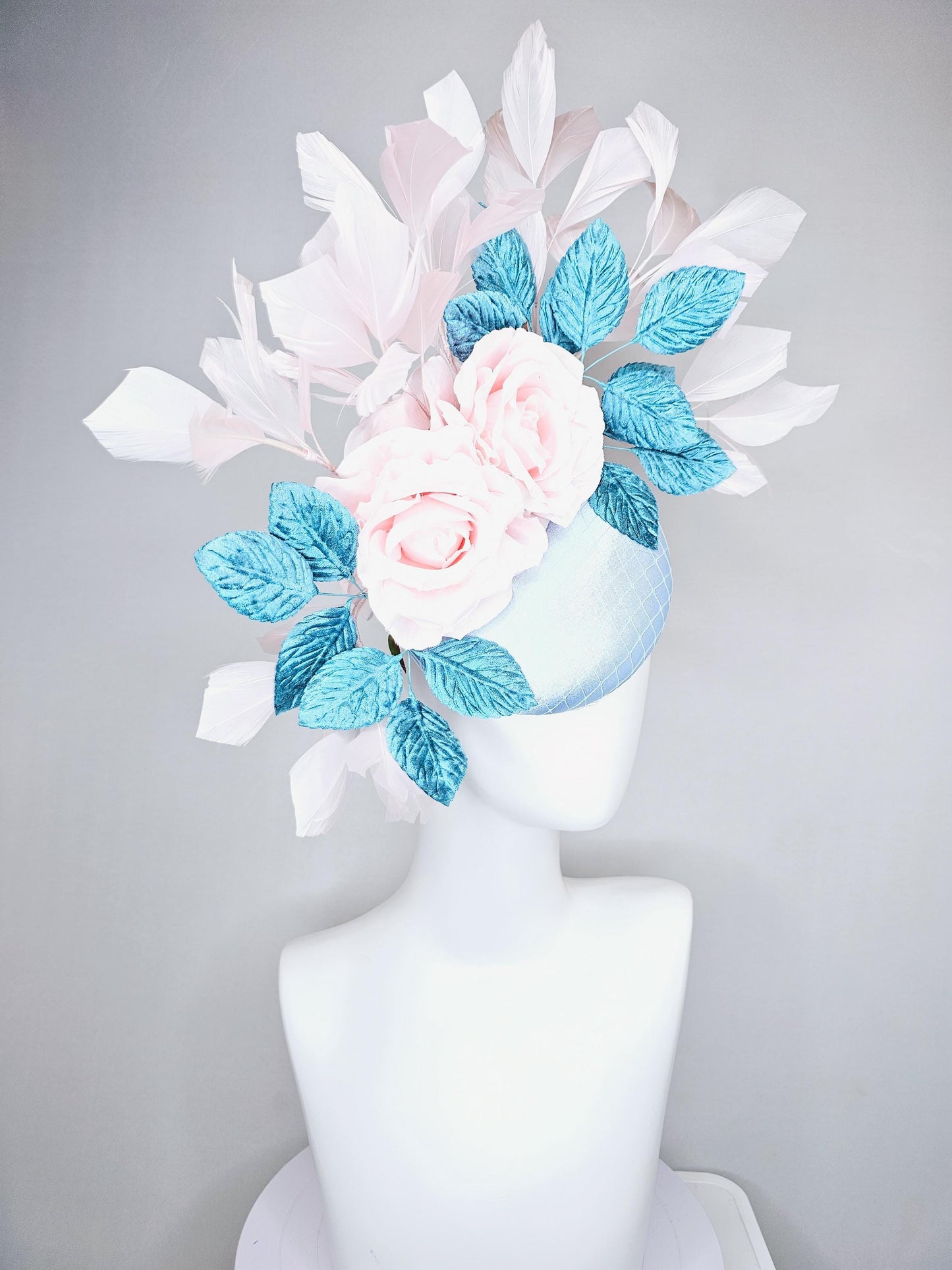 kentucky derby hat fascinator light blue satin with netting, light pink satin rose flowers, blue leaves, light pink branching feathers