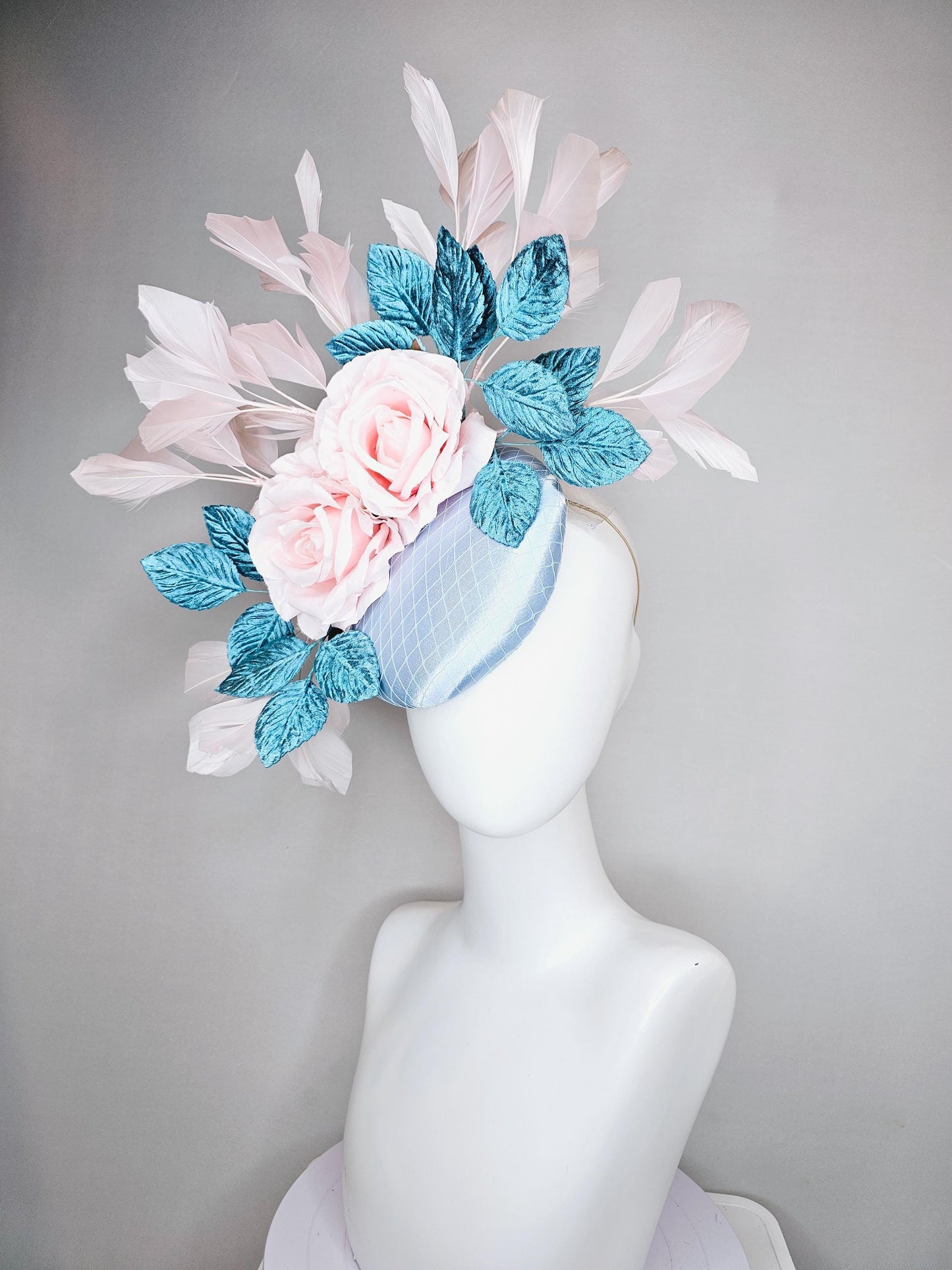 kentucky derby hat fascinator light blue satin with netting, light pink satin rose flowers, blue leaves, light pink branching feathers