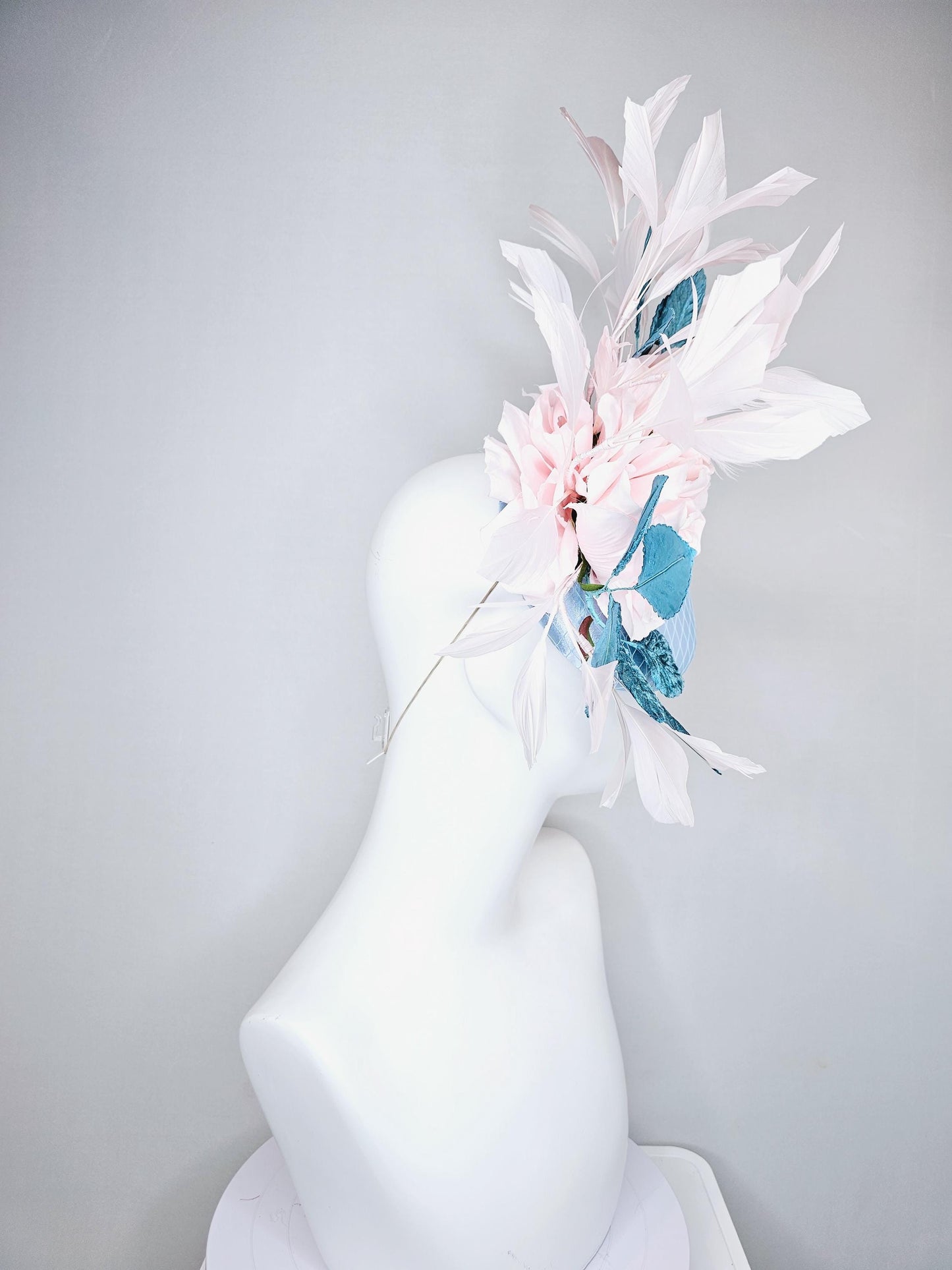 kentucky derby hat fascinator light blue satin with netting, light pink satin rose flowers, blue leaves, light pink branching feathers