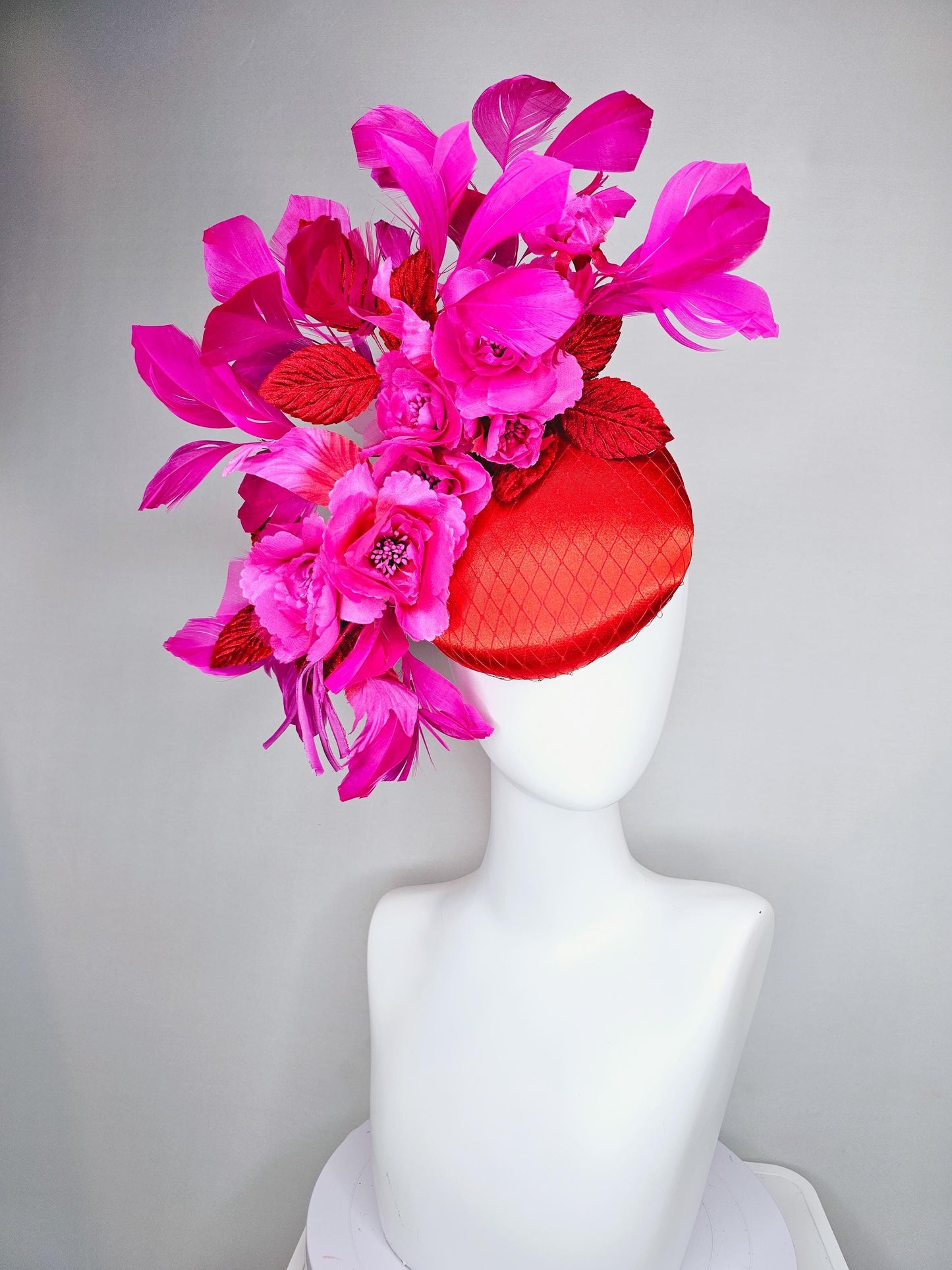 kentucky derby hat fascinator red satin with netting,bright pink fuchsia satin flowers, scarlet red leaves, bright pink branching feathers