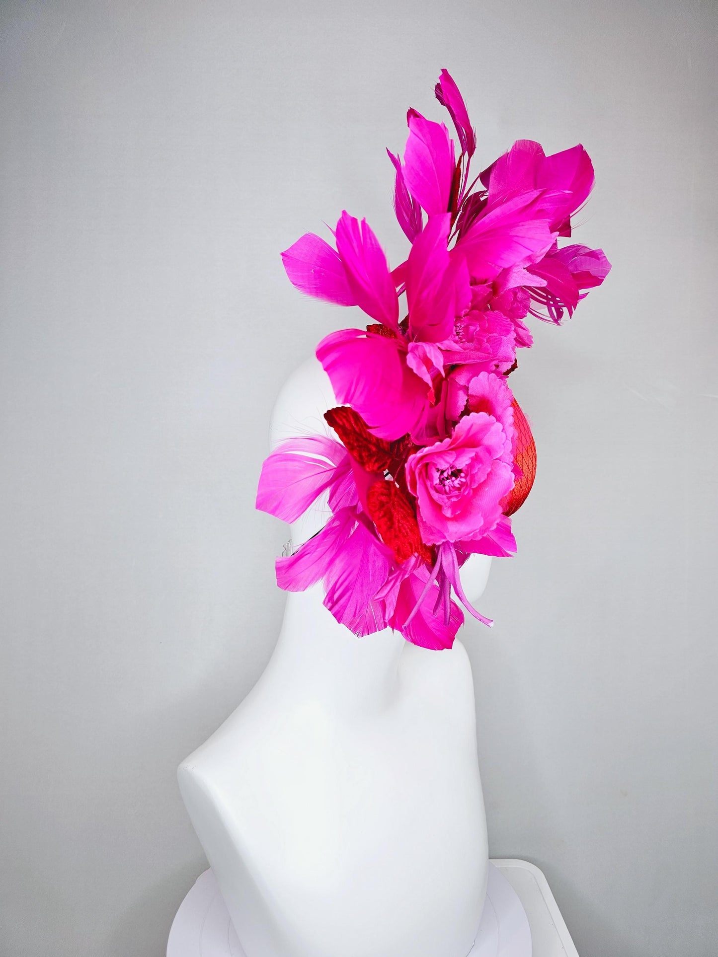 kentucky derby hat fascinator red satin with netting,bright pink fuchsia satin flowers, scarlet red leaves, bright pink branching feathers