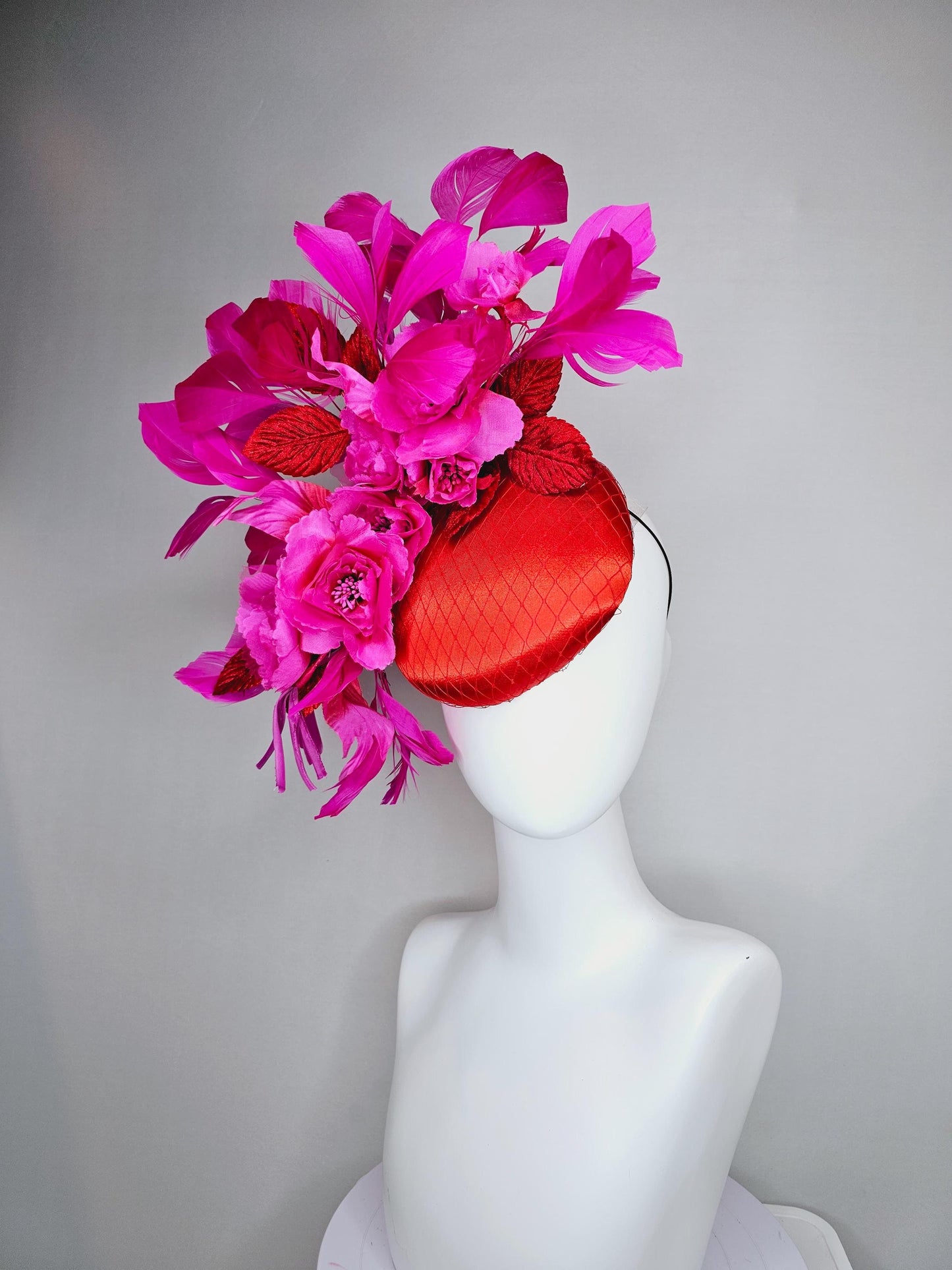 kentucky derby hat fascinator red satin with netting,bright pink fuchsia satin flowers, scarlet red leaves, bright pink branching feathers