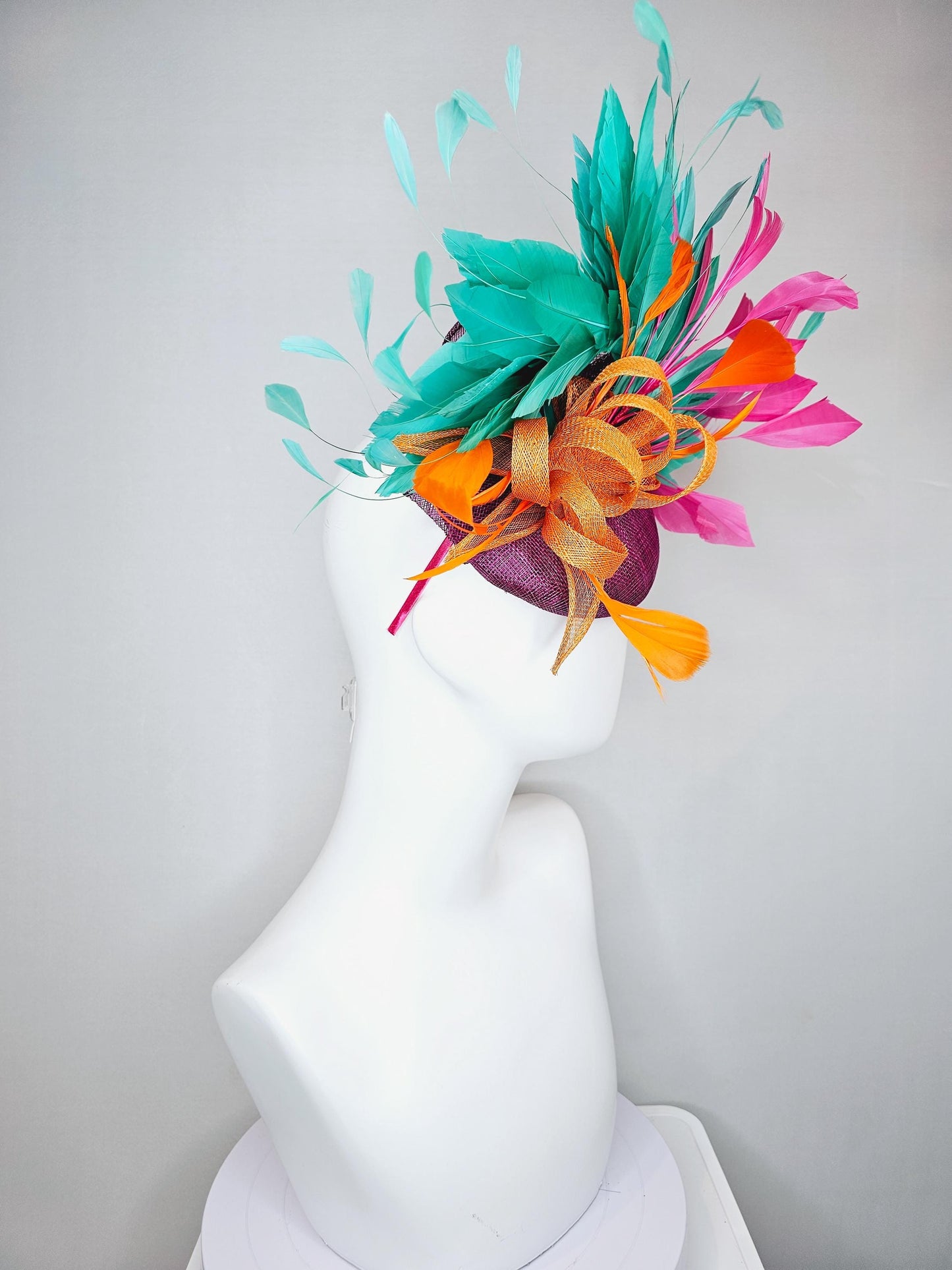 kentucky derby hat fascinator magenta purple sinamay with orange sinamay bow and orange feathers,pink and aqua blue green branching feathers