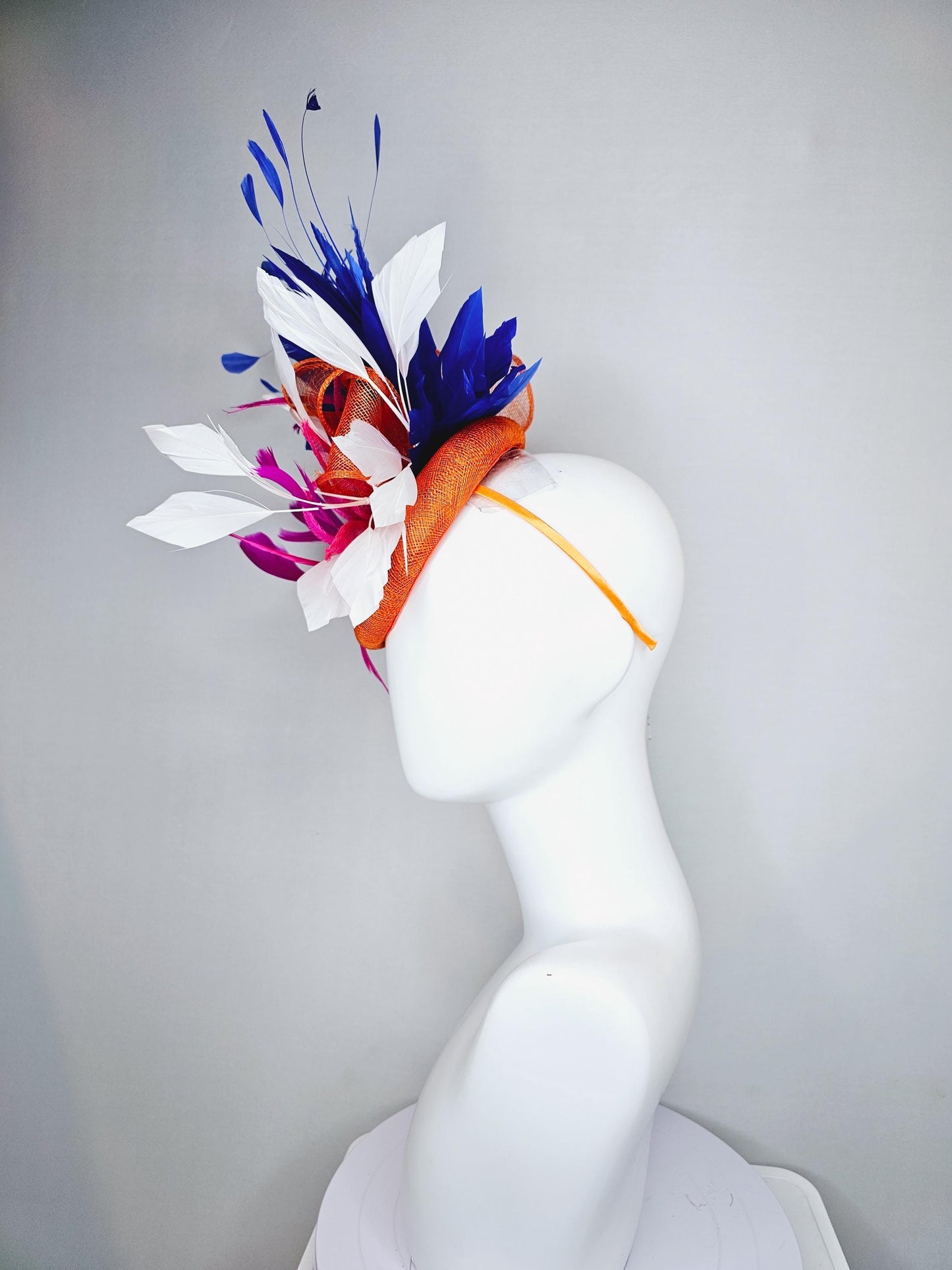 kentucky derby hat fascinator orange sinamay with pink and orange sinamay bow and pink feathers, white and royal blue branching feathers