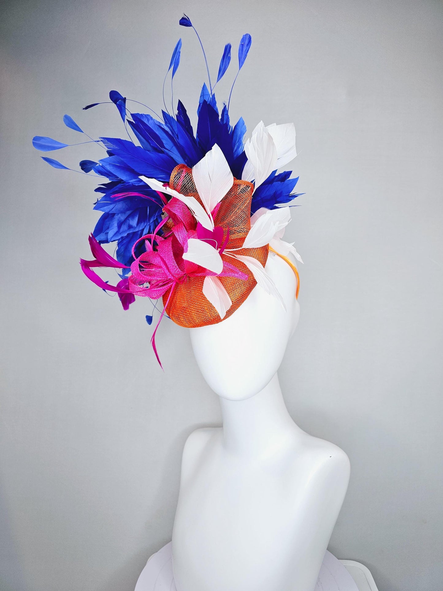 kentucky derby hat fascinator orange sinamay with pink and orange sinamay bow and pink feathers, white and royal blue branching feathers