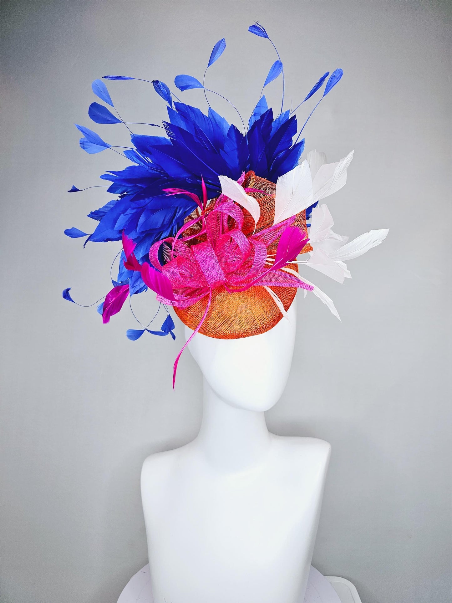 kentucky derby hat fascinator orange sinamay with pink and orange sinamay bow and pink feathers, white and royal blue branching feathers