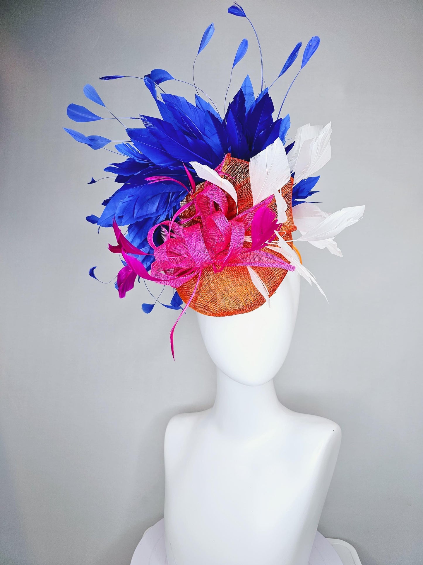 kentucky derby hat fascinator orange sinamay with pink and orange sinamay bow and pink feathers, white and royal blue branching feathers