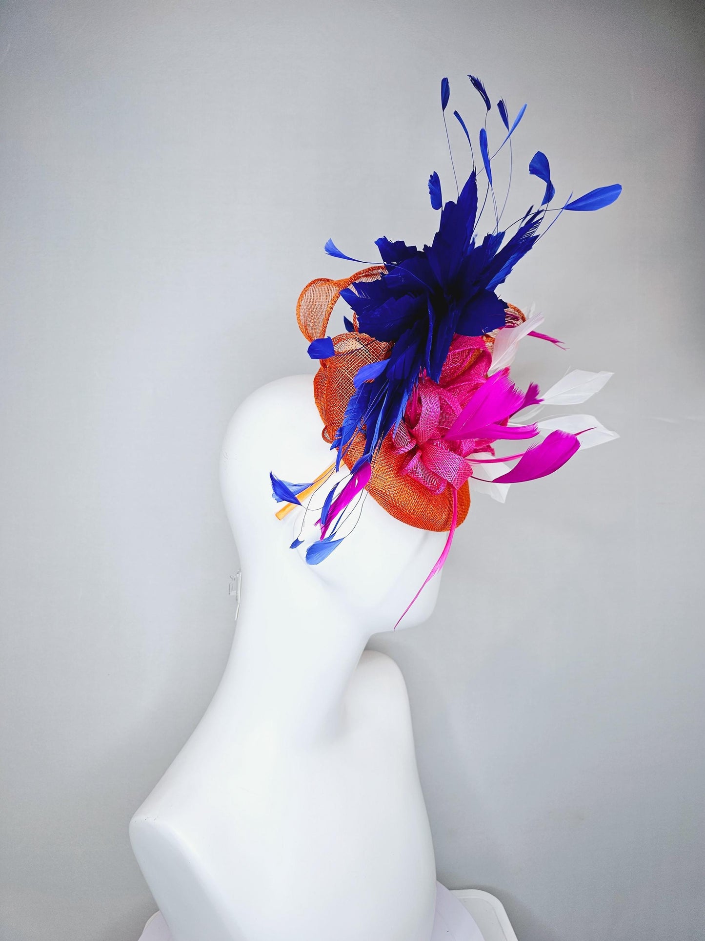 kentucky derby hat fascinator orange sinamay with pink and orange sinamay bow and pink feathers, white and royal blue branching feathers