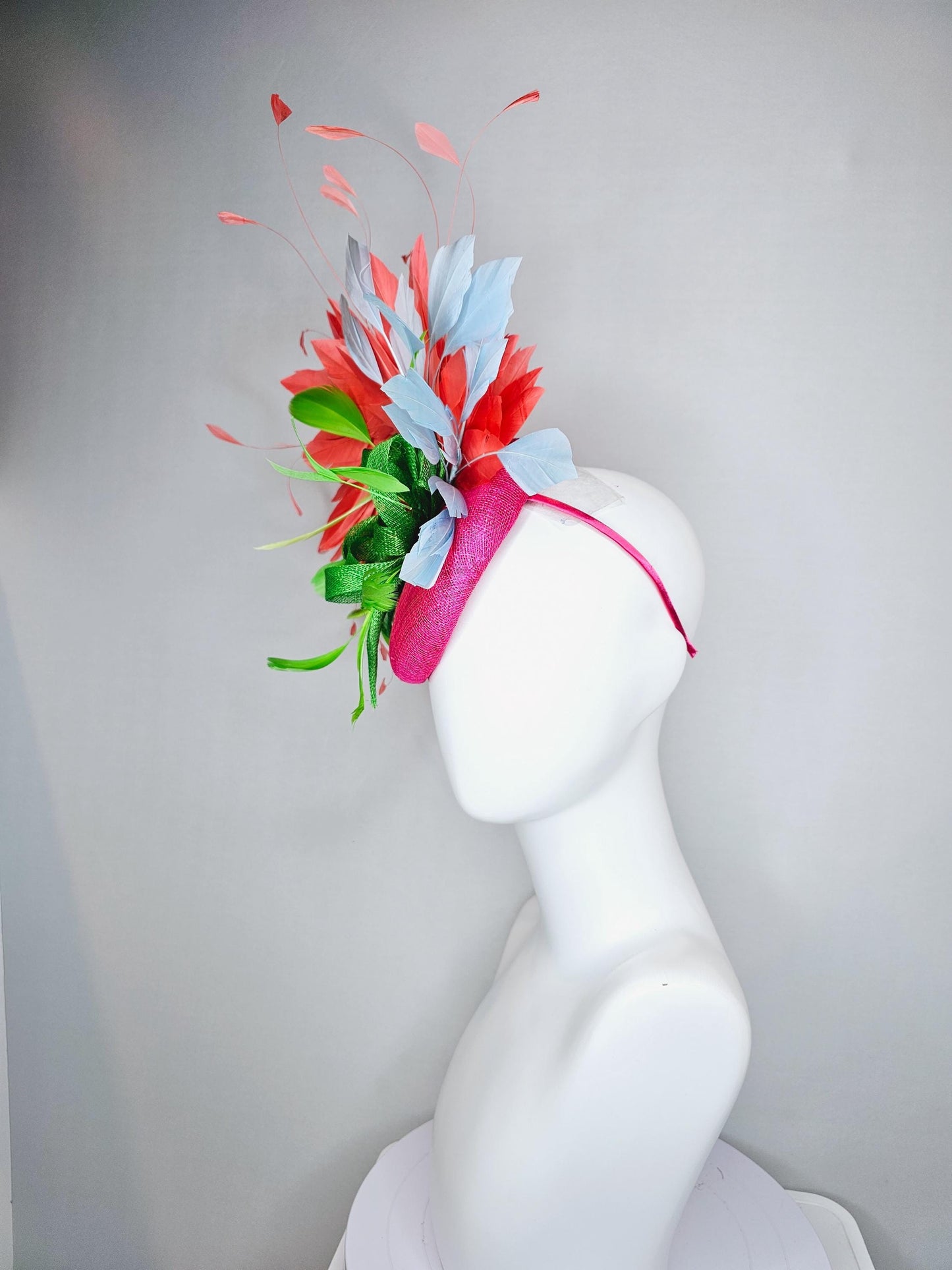 kentucky derby hat fascinator pink sinamay with green sinamay bow and lime green feathers, light blue and coral orange branching feathers