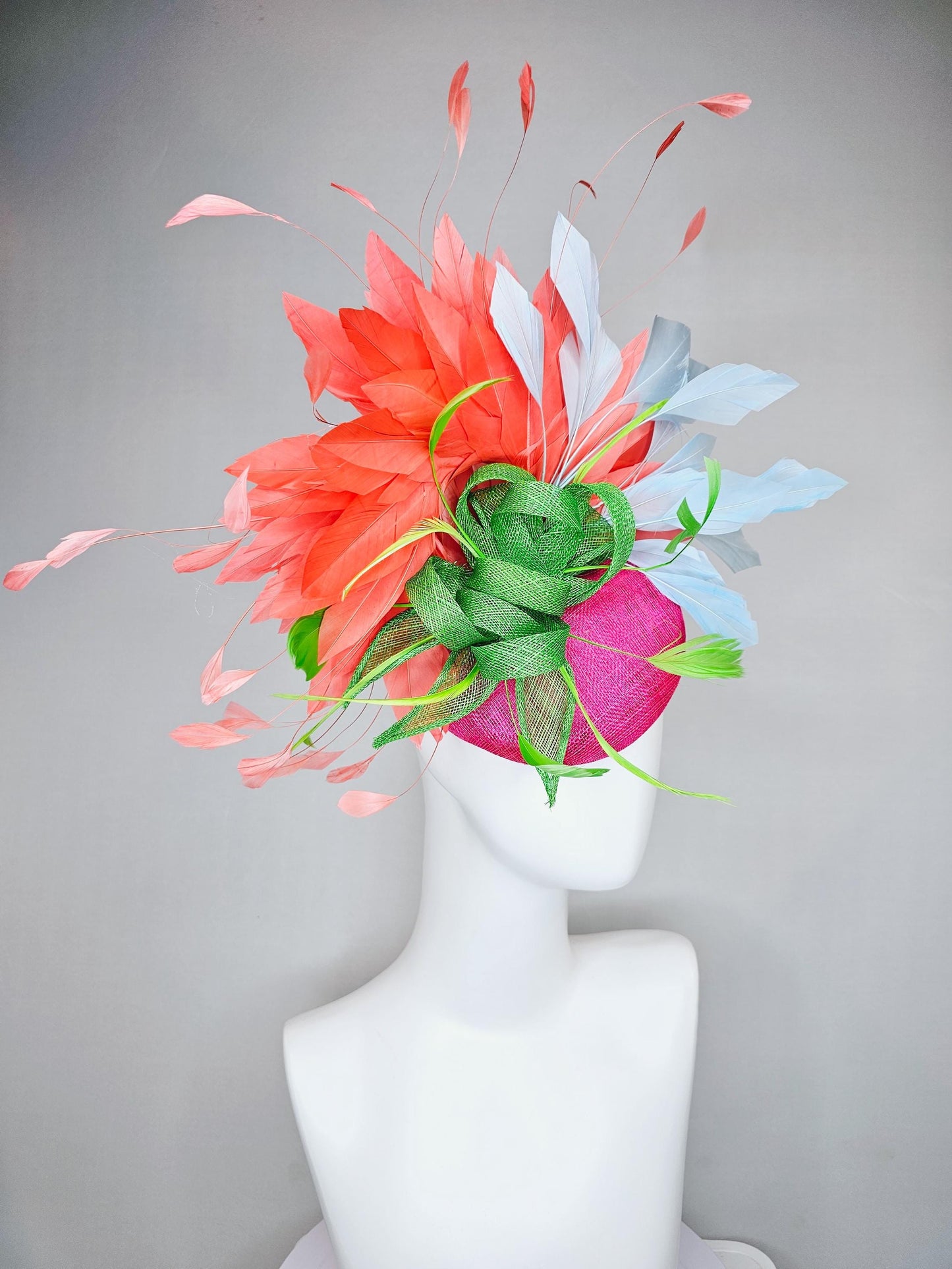 kentucky derby hat fascinator pink sinamay with green sinamay bow and lime green feathers, light blue and coral orange branching feathers