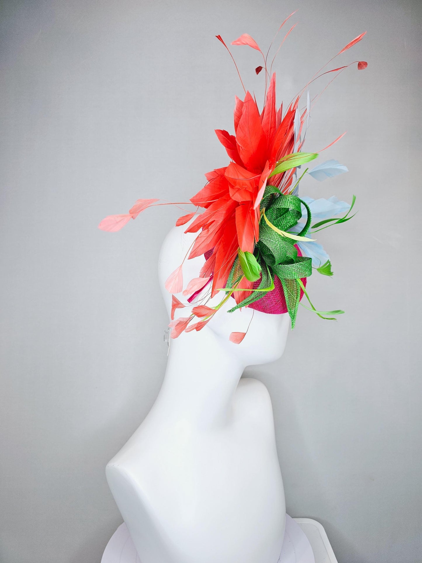 kentucky derby hat fascinator pink sinamay with green sinamay bow and lime green feathers, light blue and coral orange branching feathers