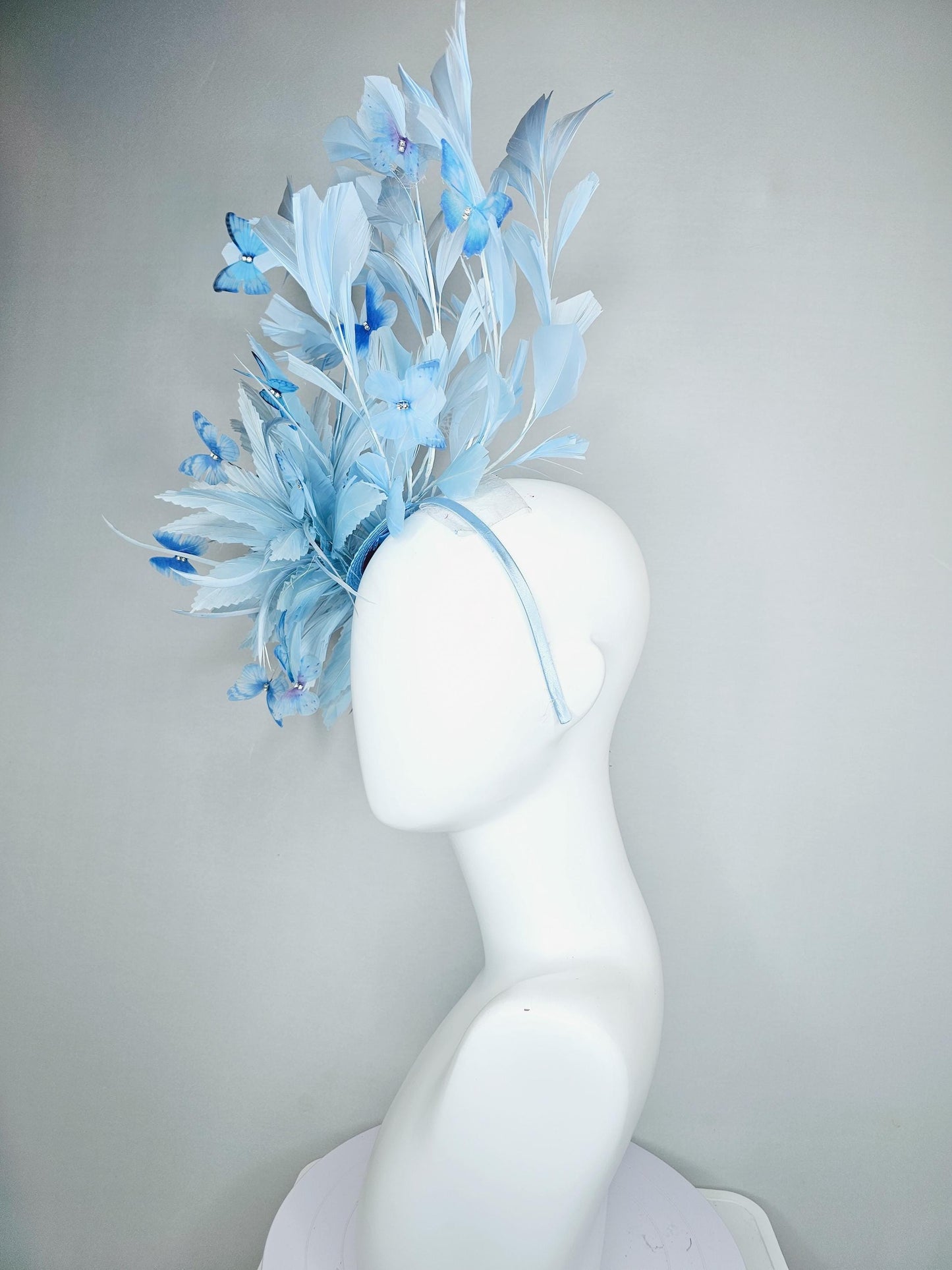 kentucky derby hat fascinator with fluffy light baby blue zigzag feathers, light baby blue branching feathers, light sky blue butterflies