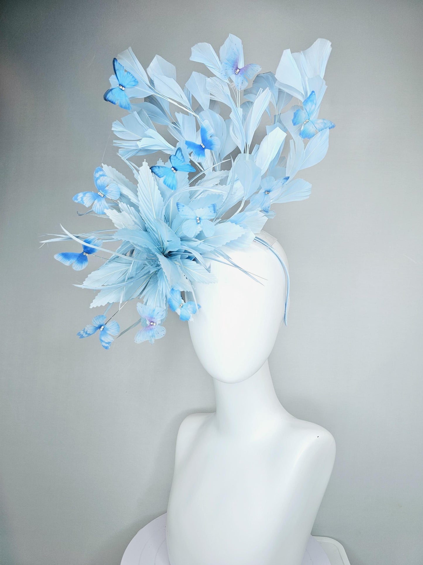 kentucky derby hat fascinator with fluffy light baby blue zigzag feathers, light baby blue branching feathers, light sky blue butterflies