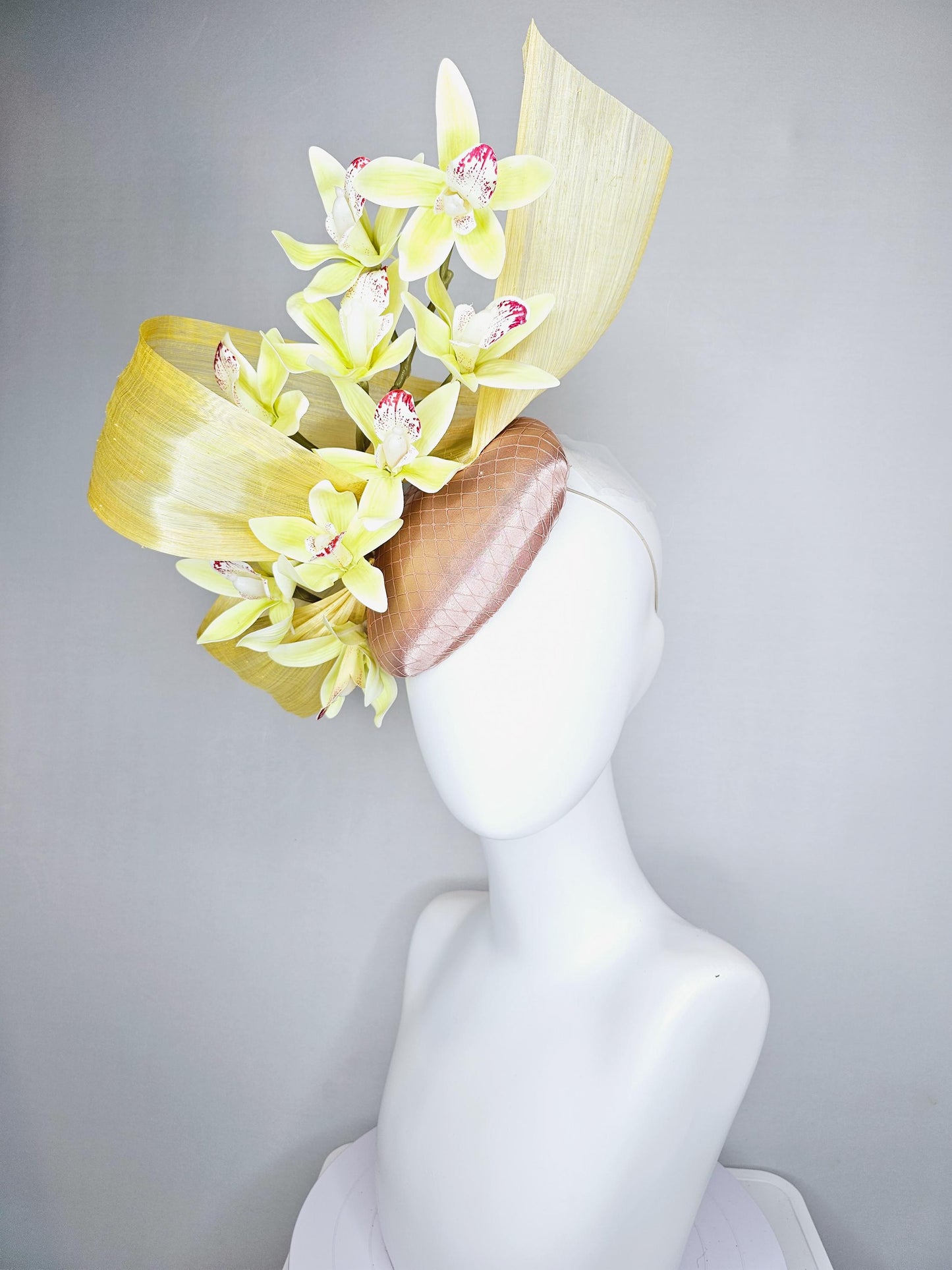 kentucky derby hat fascinator light pink satin with netting, yellow and wine red orchid flowers, yellow silk ribbon large bendable decor