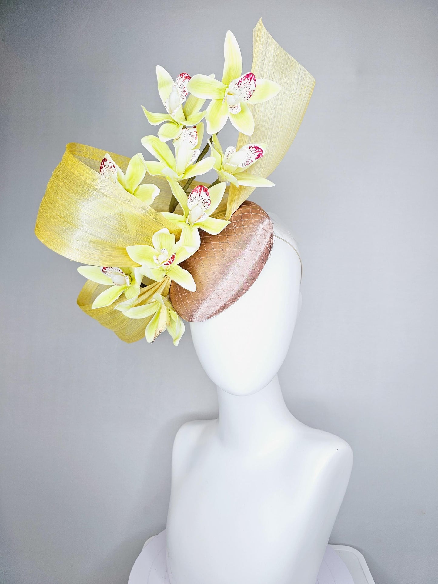 kentucky derby hat fascinator light pink satin with netting, yellow and wine red orchid flowers, yellow silk ribbon large bendable decor