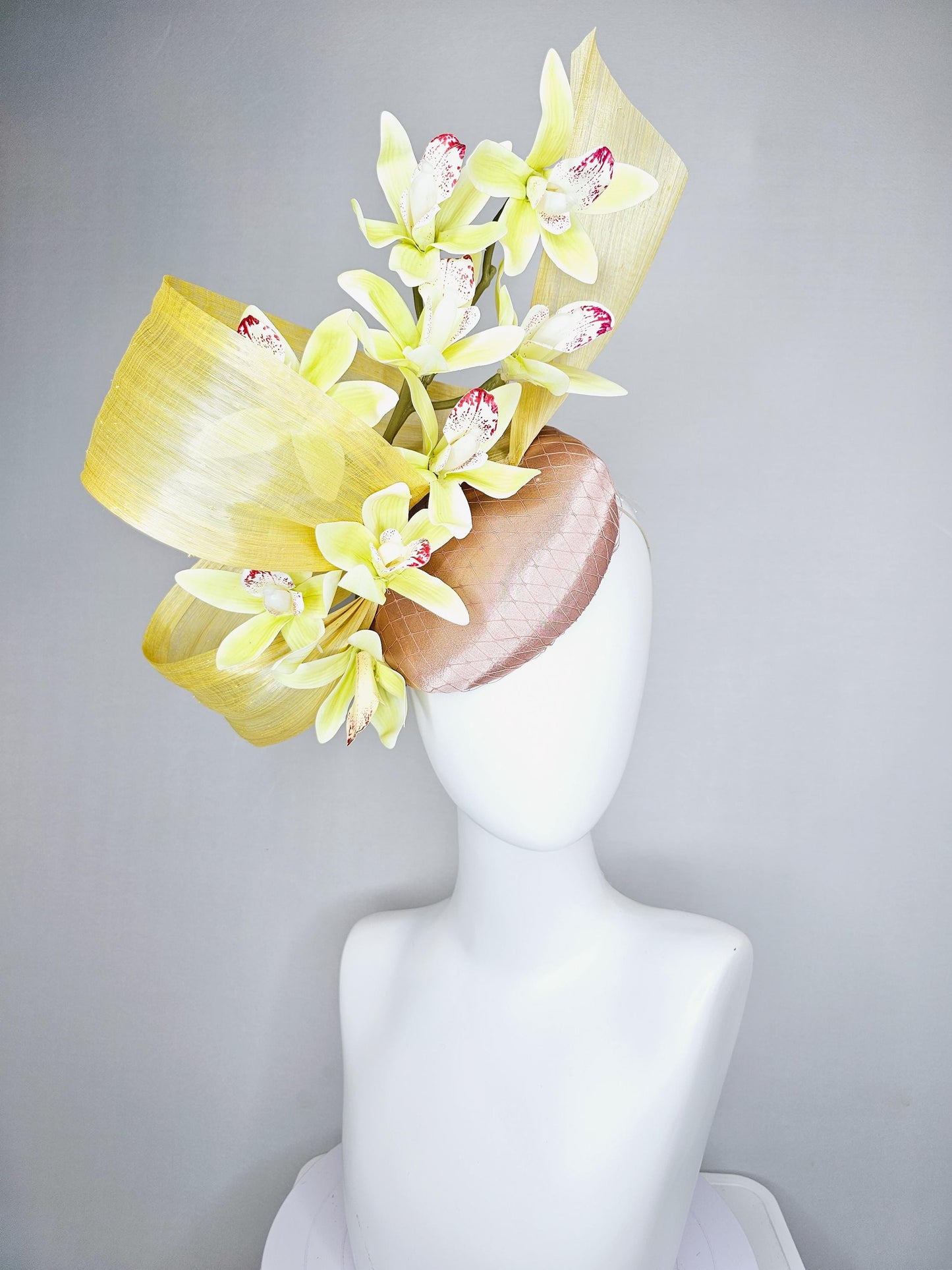 kentucky derby hat fascinator light pink satin with netting, yellow and wine red orchid flowers, yellow silk ribbon large bendable decor