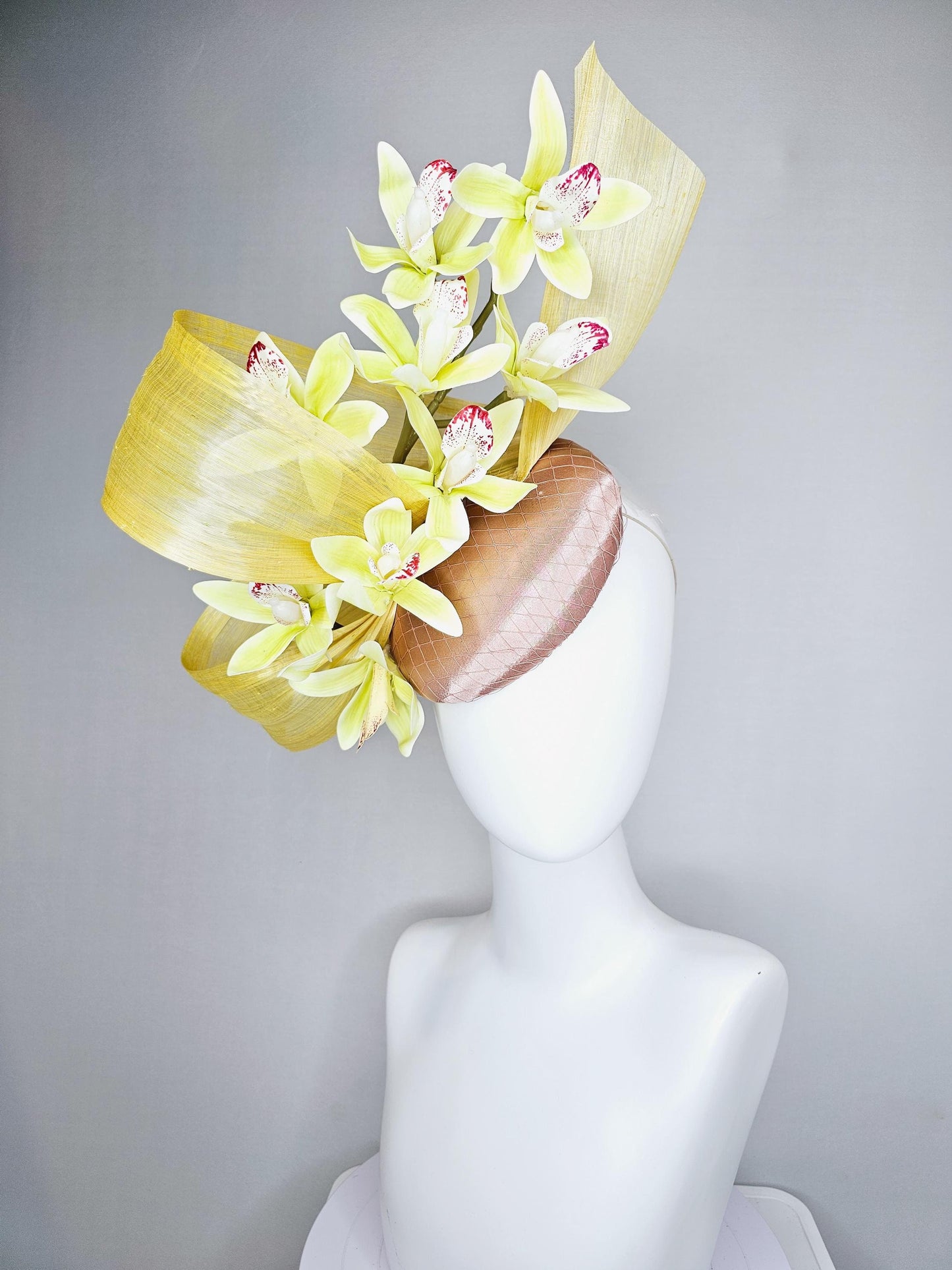 kentucky derby hat fascinator light pink satin with netting, yellow and wine red orchid flowers, yellow silk ribbon large bendable decor