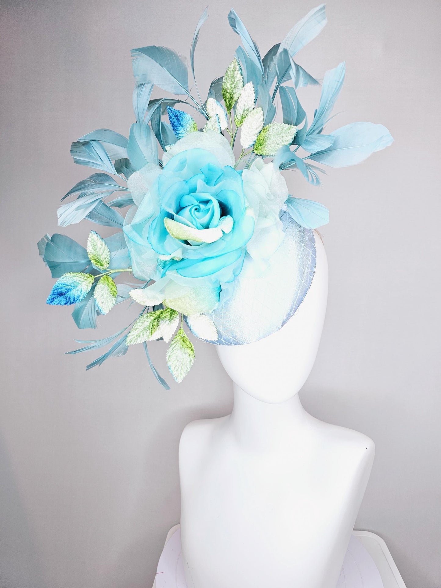 kentucky derby hat fascinator light blue satin with netting, sky blue organza rose flower,blue and green leaves,teal blue branching feathers