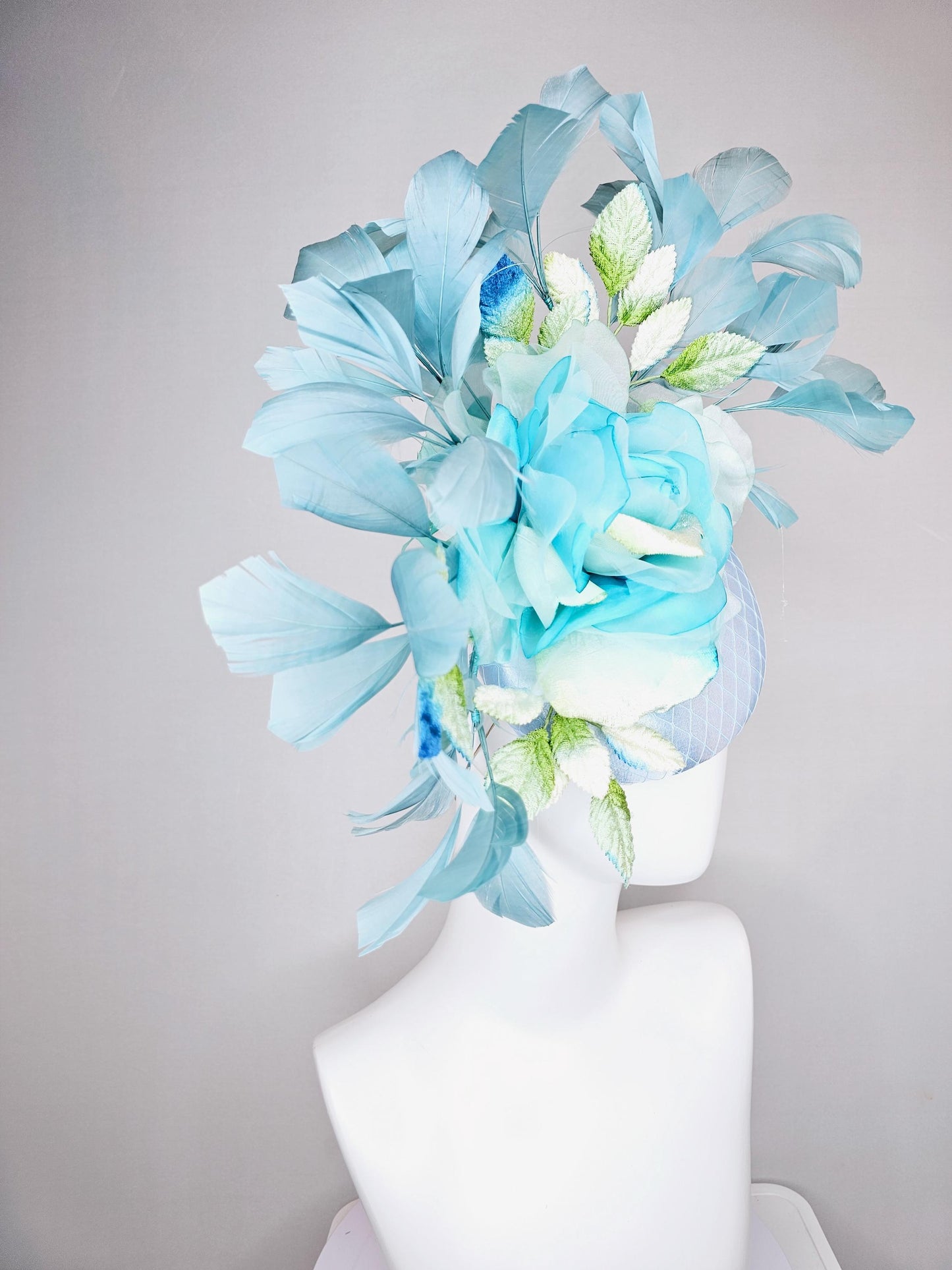 kentucky derby hat fascinator light blue satin with netting, sky blue organza rose flower,blue and green leaves,teal blue branching feathers