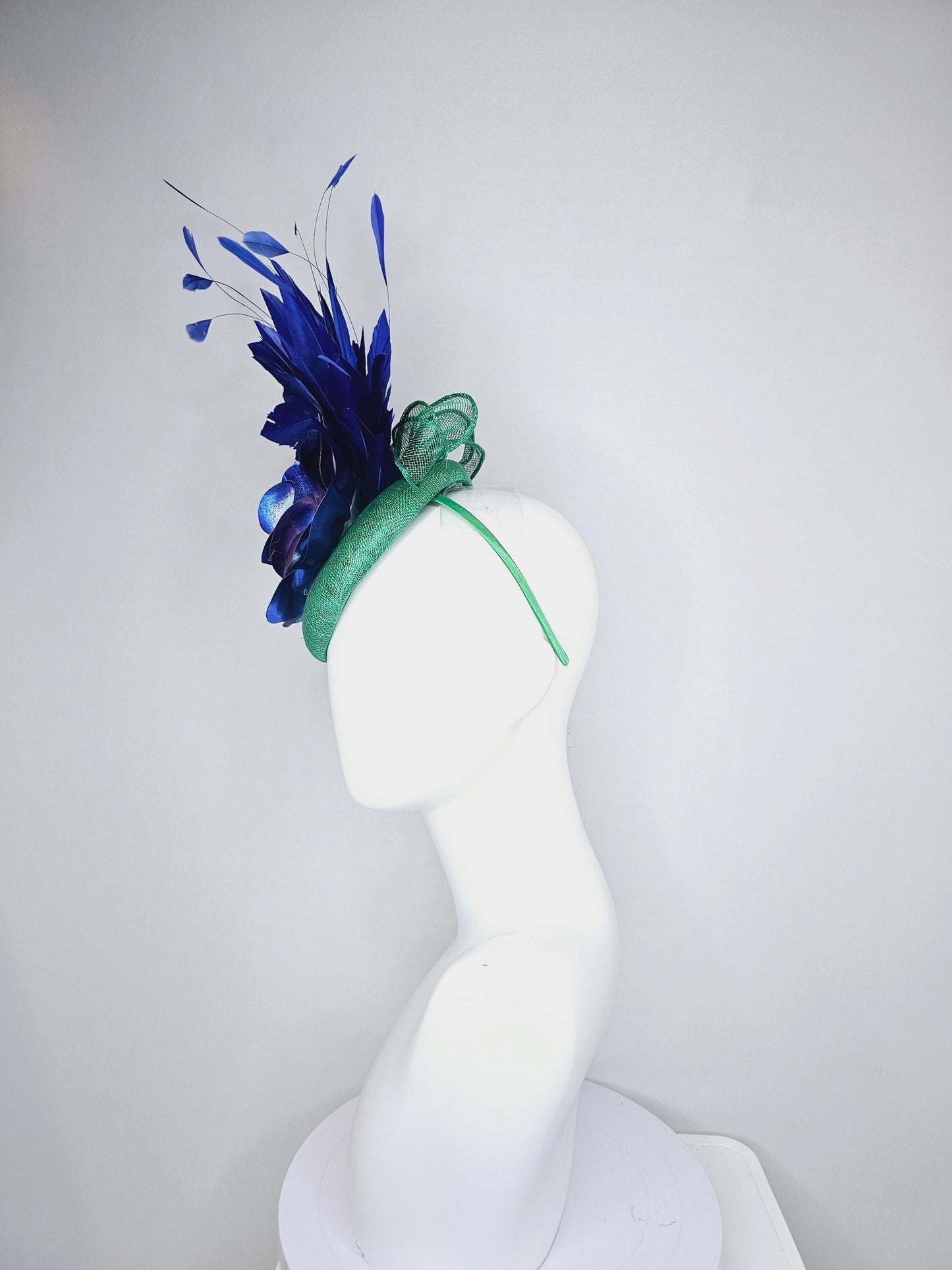 kentucky derby hat fascinator green sinamay, cobalt blue branching feathers and large blue,turquoise and purple ombre satin rose flower