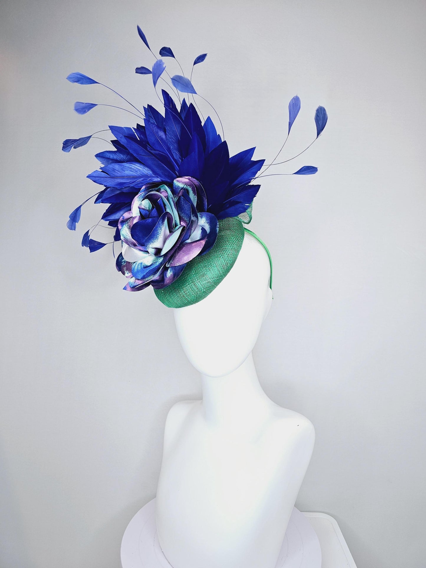 kentucky derby hat fascinator green sinamay, cobalt blue branching feathers and large blue,turquoise and purple ombre satin rose flower