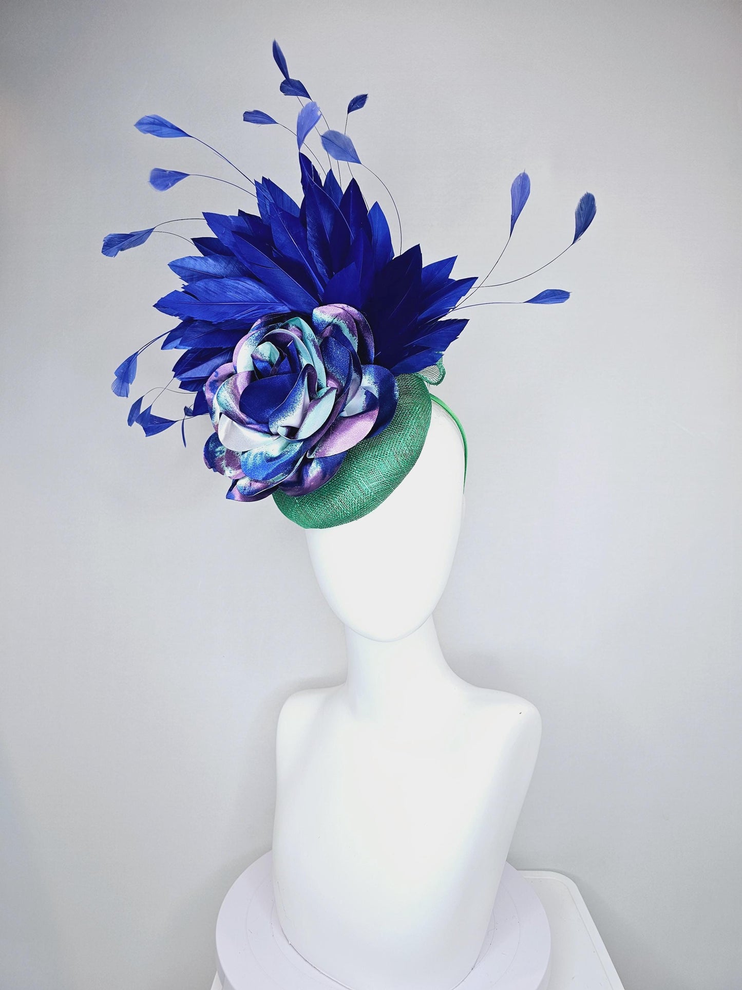 kentucky derby hat fascinator green sinamay, cobalt blue branching feathers and large blue,turquoise and purple ombre satin rose flower