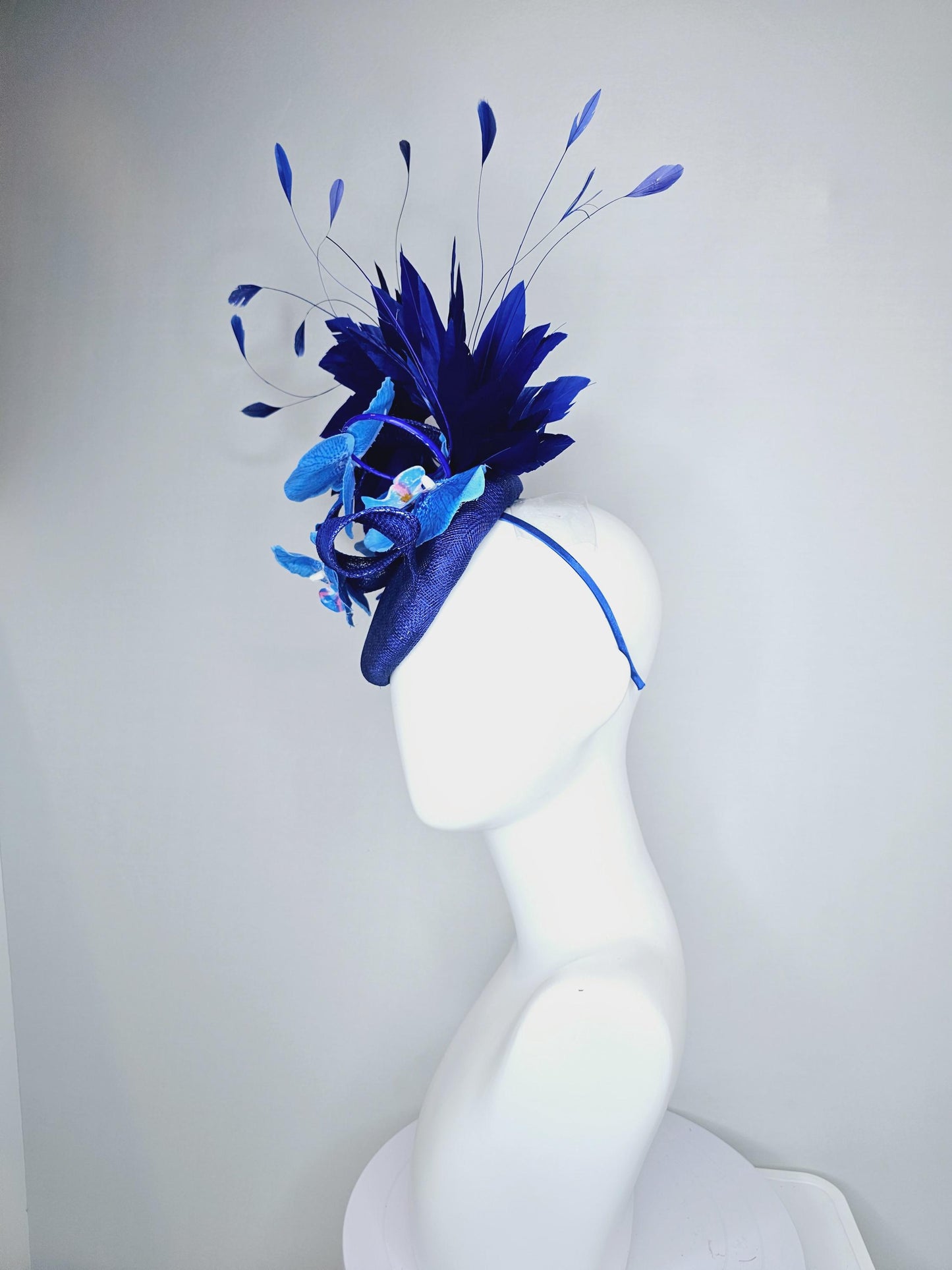 kentucky derby hat fascinator navy blue sinamay with curls, midnight royal blue branching feathers and large sky blue satin silk orchids