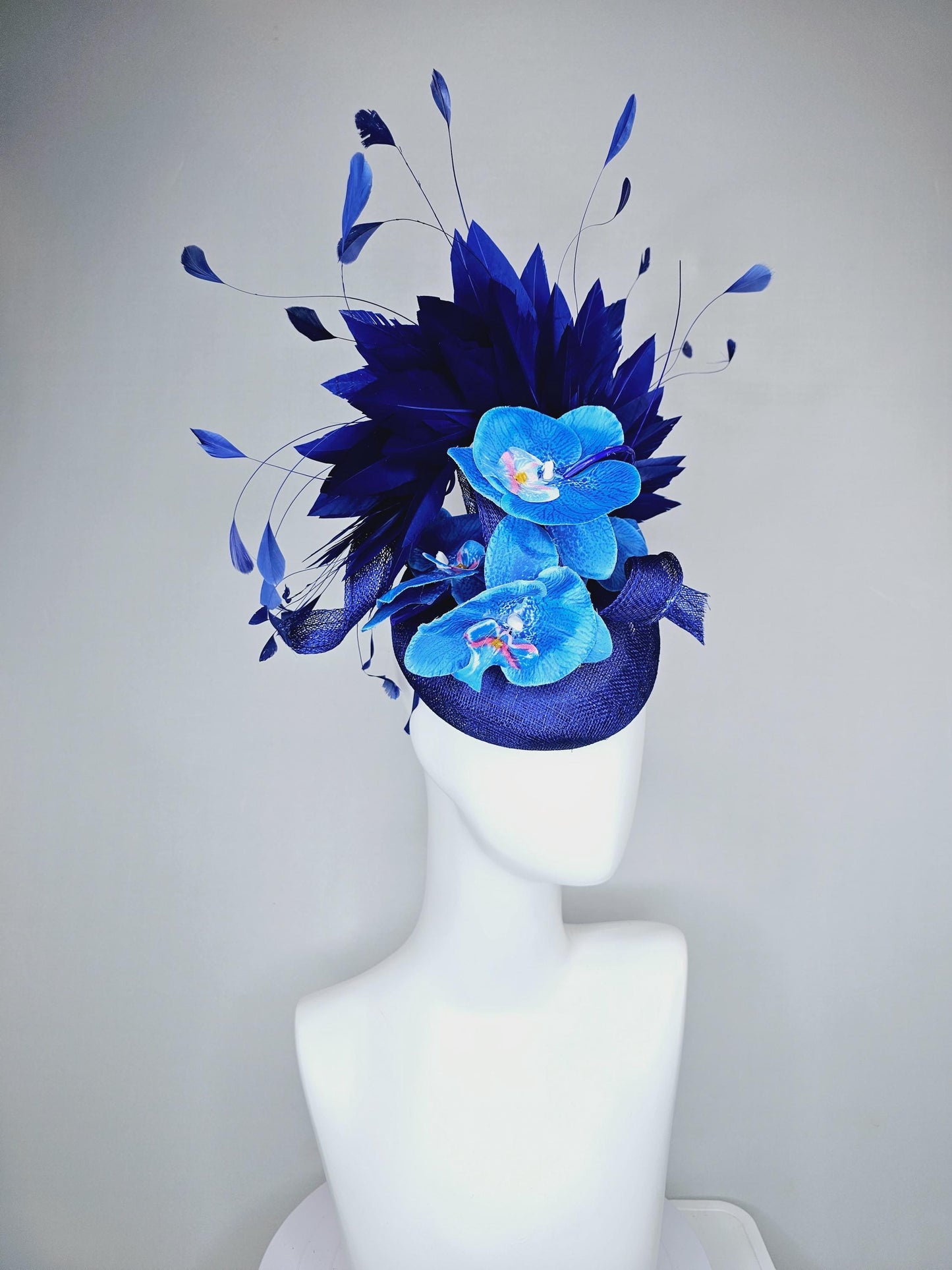 kentucky derby hat fascinator navy blue sinamay with curls, midnight royal blue branching feathers and large sky blue satin silk orchids