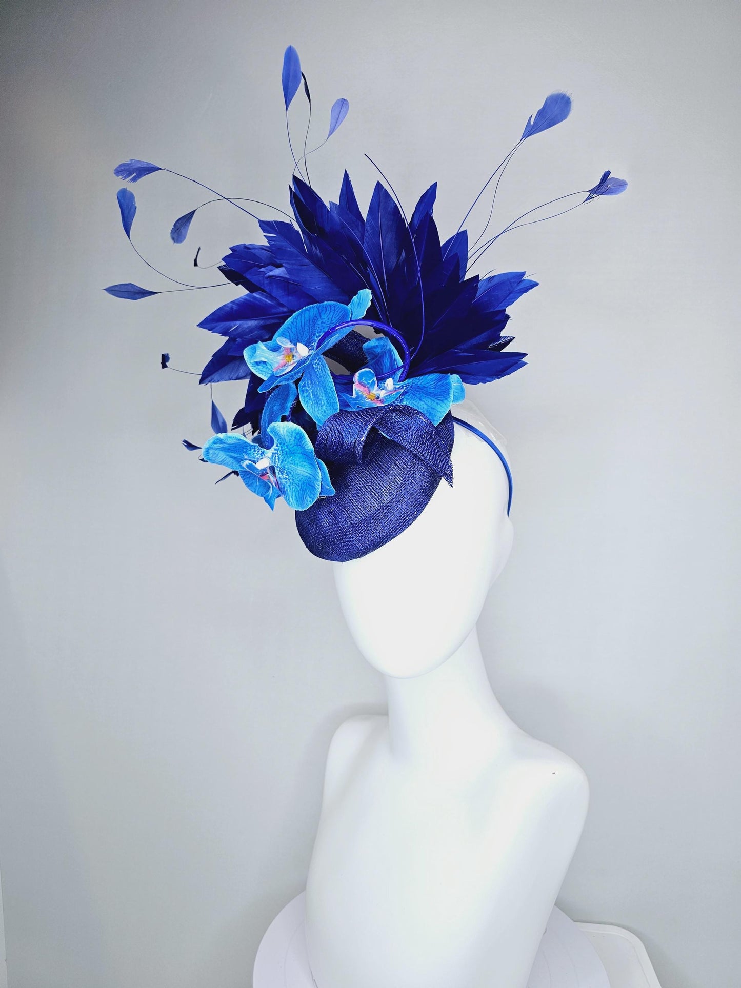 kentucky derby hat fascinator navy blue sinamay with curls, midnight royal blue branching feathers and large sky blue satin silk orchids