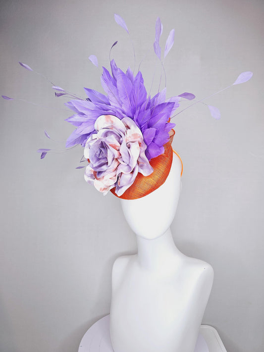 kentucky derby hat fascinator orange sinamay with lavender purple branching feathers and large purple and orange tie dye satin rose flower