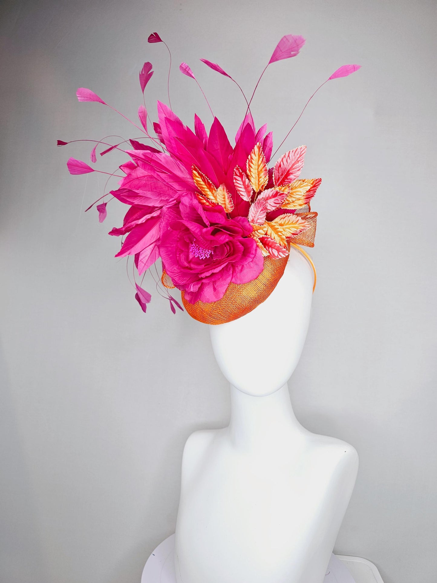 kentucky derby hat fascinator burnt orange sinamay with bright pink satin rose flower, red orange leaves, bright pink branching feathers