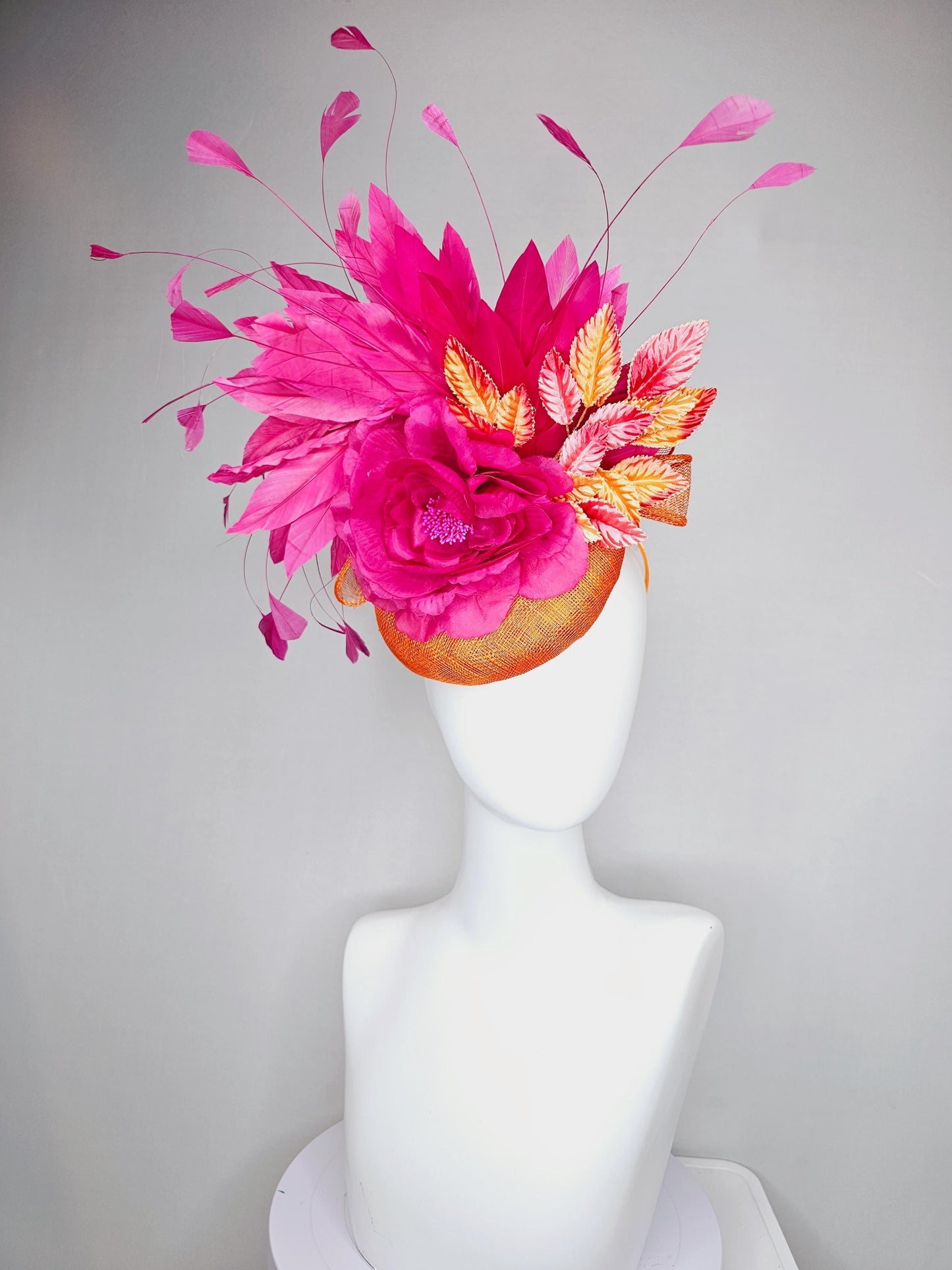 kentucky derby hat fascinator burnt orange sinamay with bright pink satin rose flower, red orange leaves, bright pink branching feathers