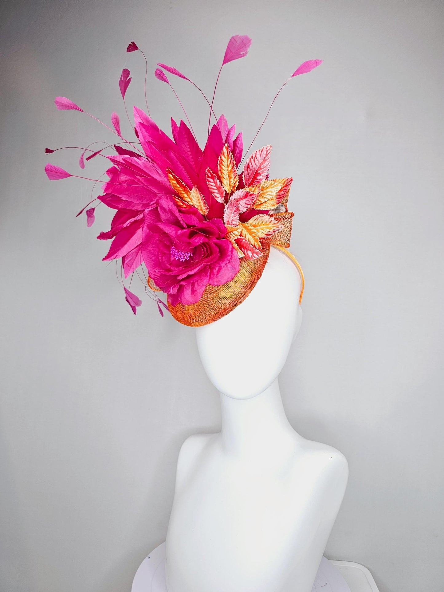 kentucky derby hat fascinator burnt orange sinamay with bright pink satin rose flower, red orange leaves, bright pink branching feathers