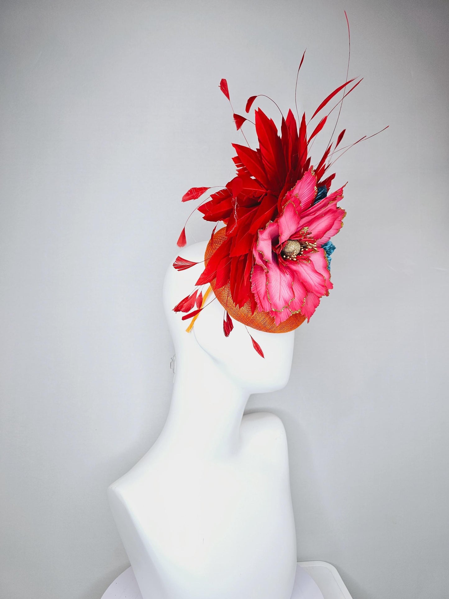 kentucky derby hat fascinator burnt orange sinamay with scarlet red branching feathers, large ombre cherry red satin flower,teal blue leaves