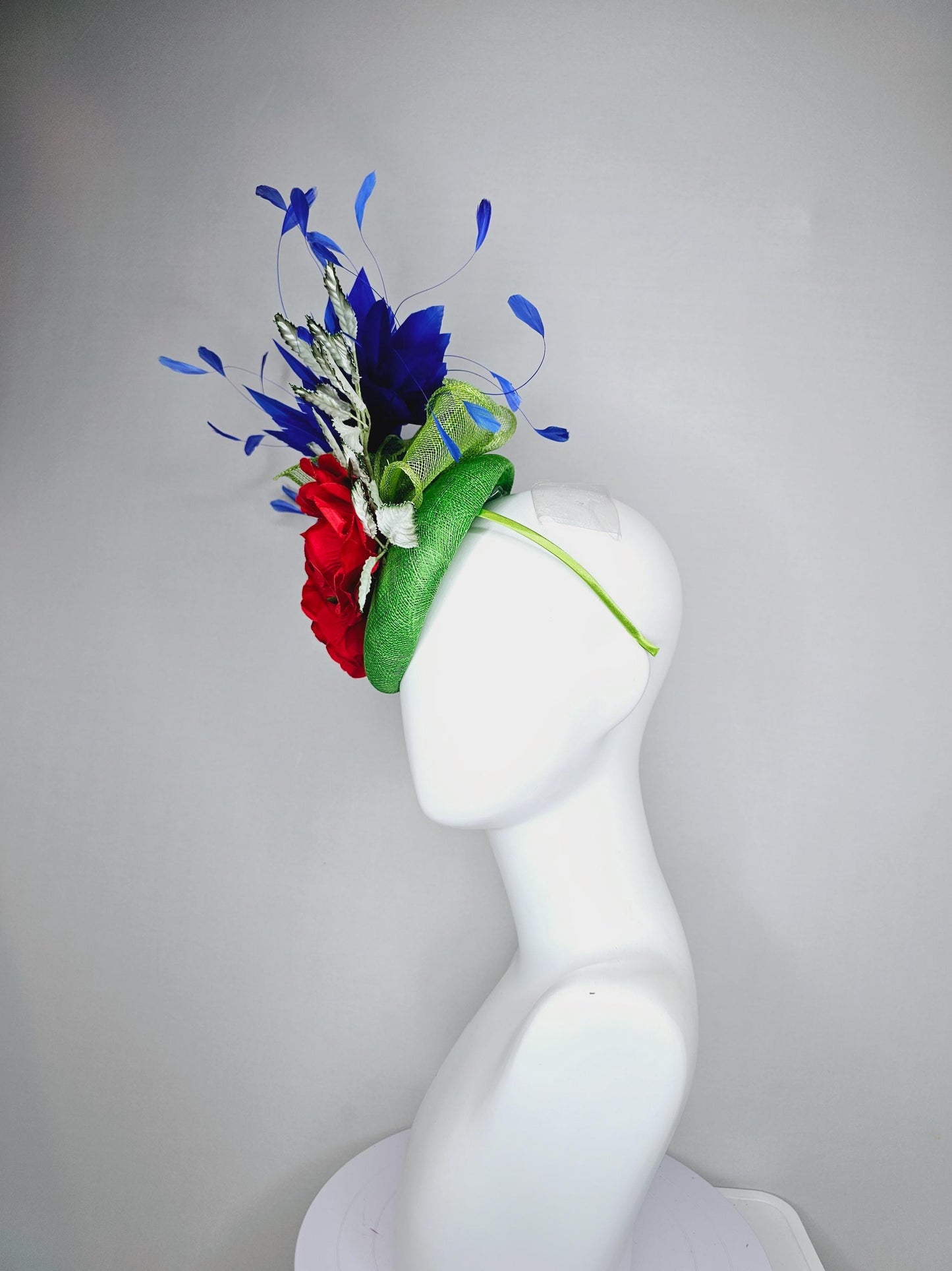 kentucky derby hat fascinator green sinamay with royal blue branching feathers,light green ombre leaves and bright red satin silk roses