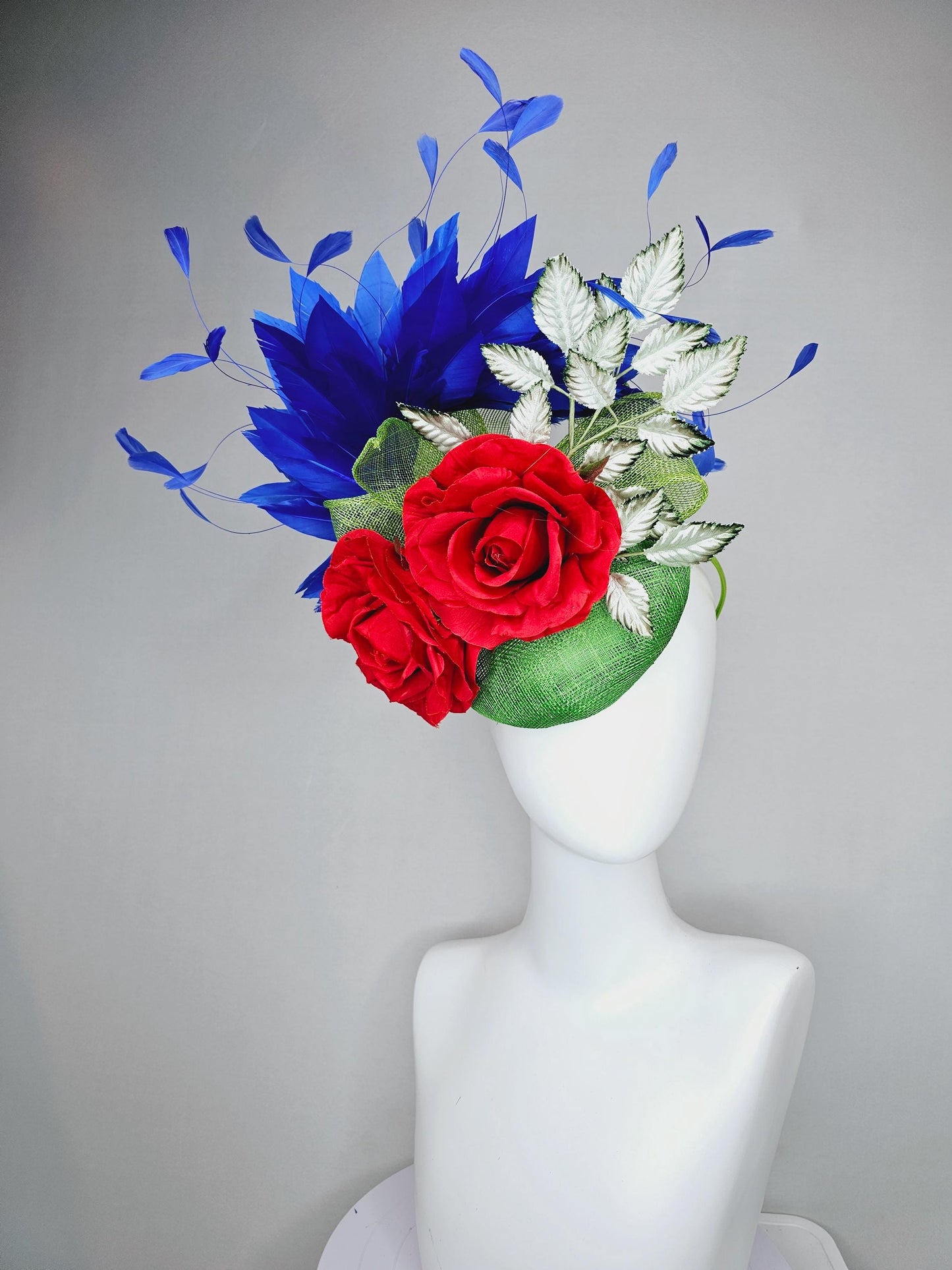 kentucky derby hat fascinator green sinamay with royal blue branching feathers,light green ombre leaves and bright red satin silk roses