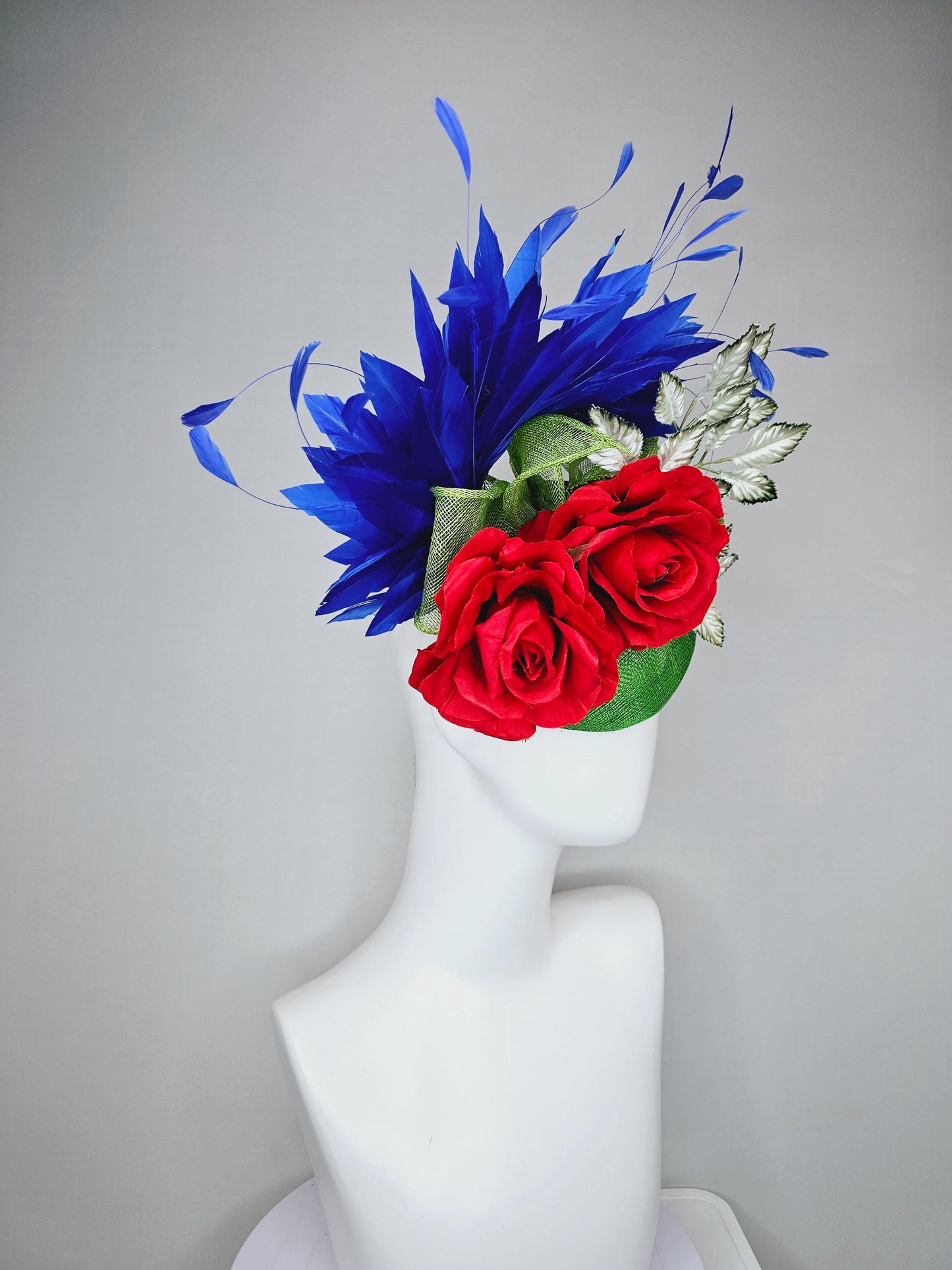 kentucky derby hat fascinator green sinamay with royal blue branching feathers,light green ombre leaves and bright red satin silk roses