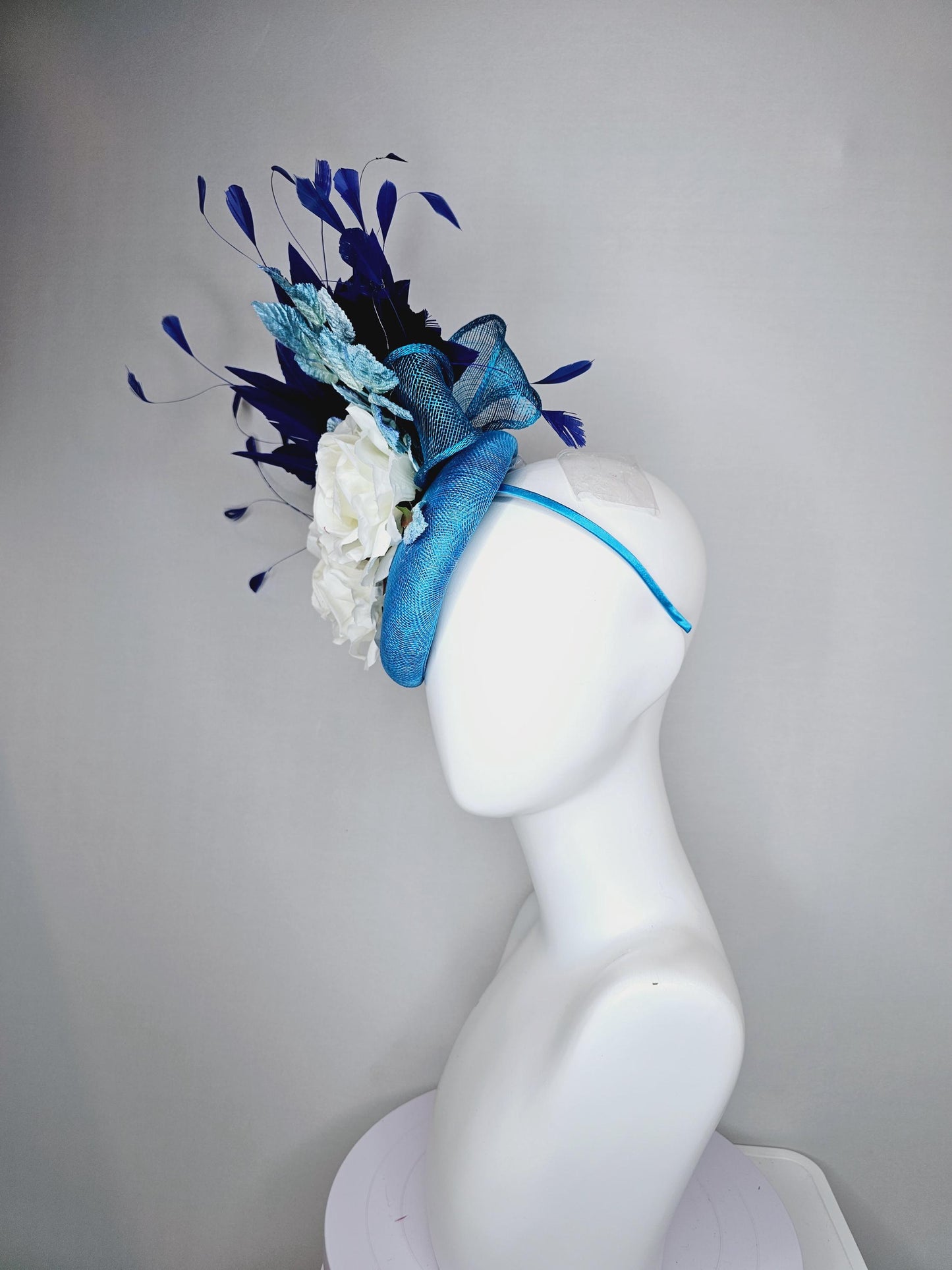 kentucky derby hat fascinator blue sinamay with midnight navy blue branching feathers,light blue ombre leaves,white satin silk rose flowers