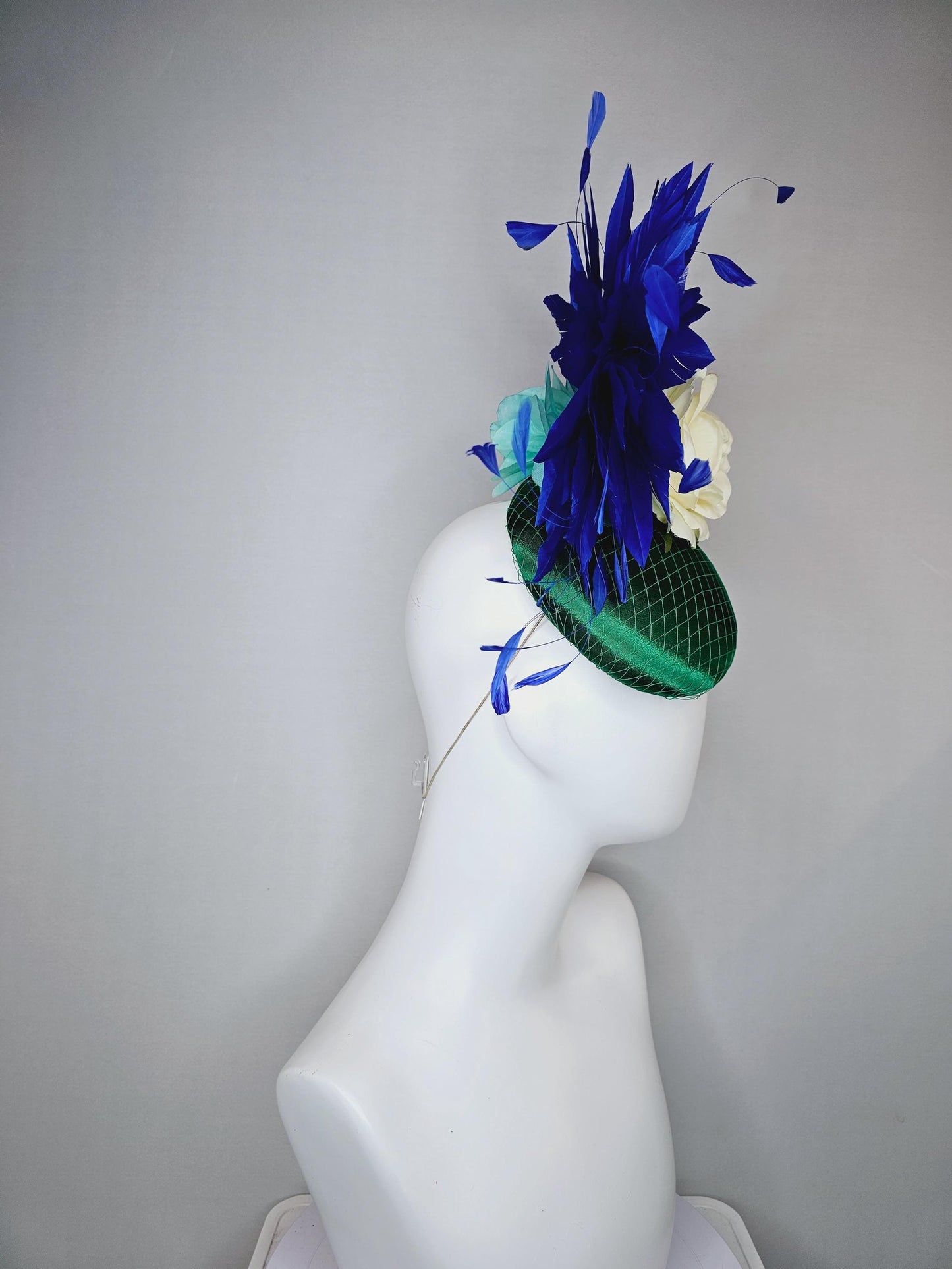 kentucky derby hat fascinator green satin with netting,white ivory satin rose flower,green leaves,royal cobalt blue branching feathers