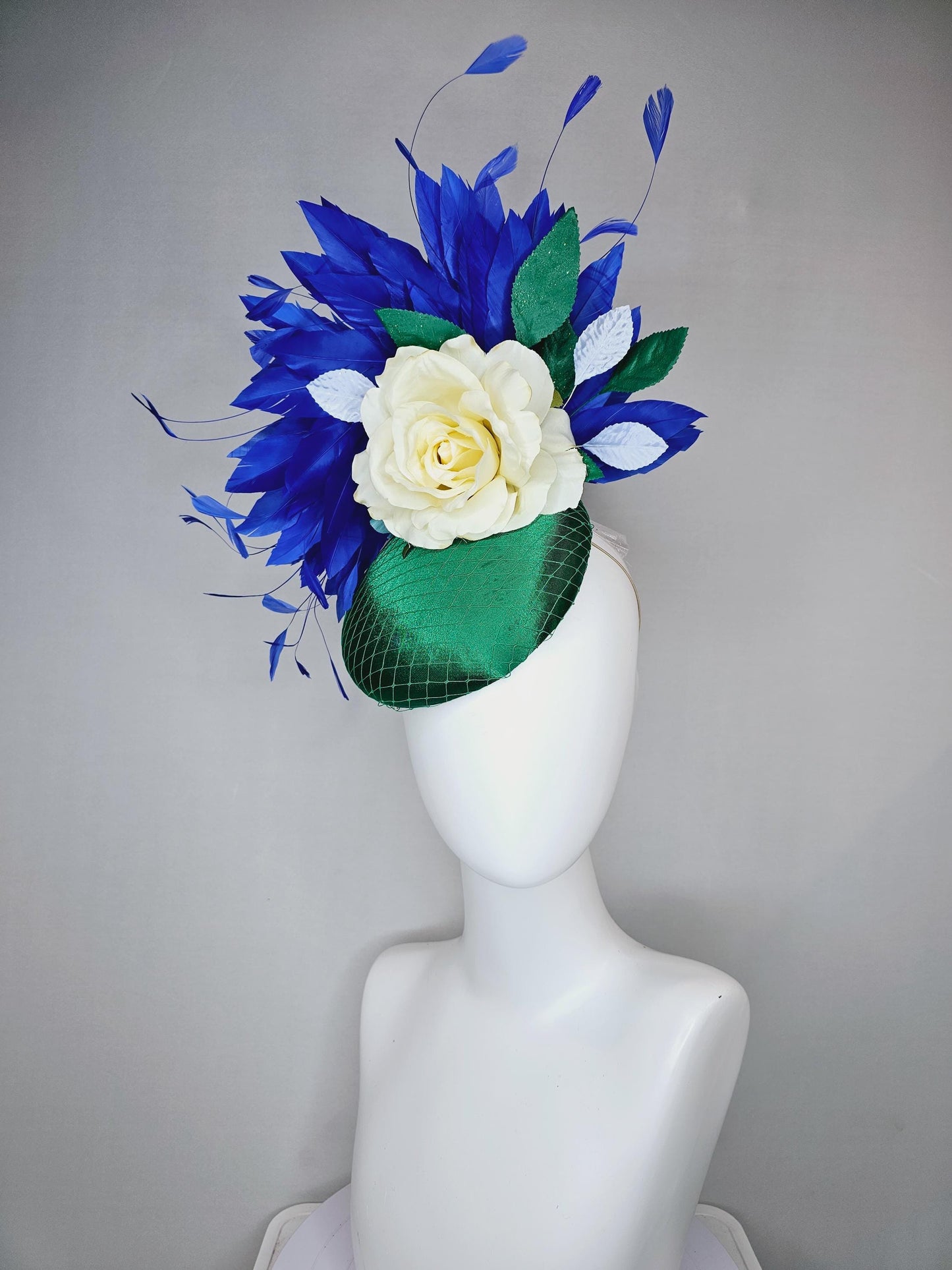 kentucky derby hat fascinator green satin with netting,white ivory satin rose flower,green leaves,royal cobalt blue branching feathers