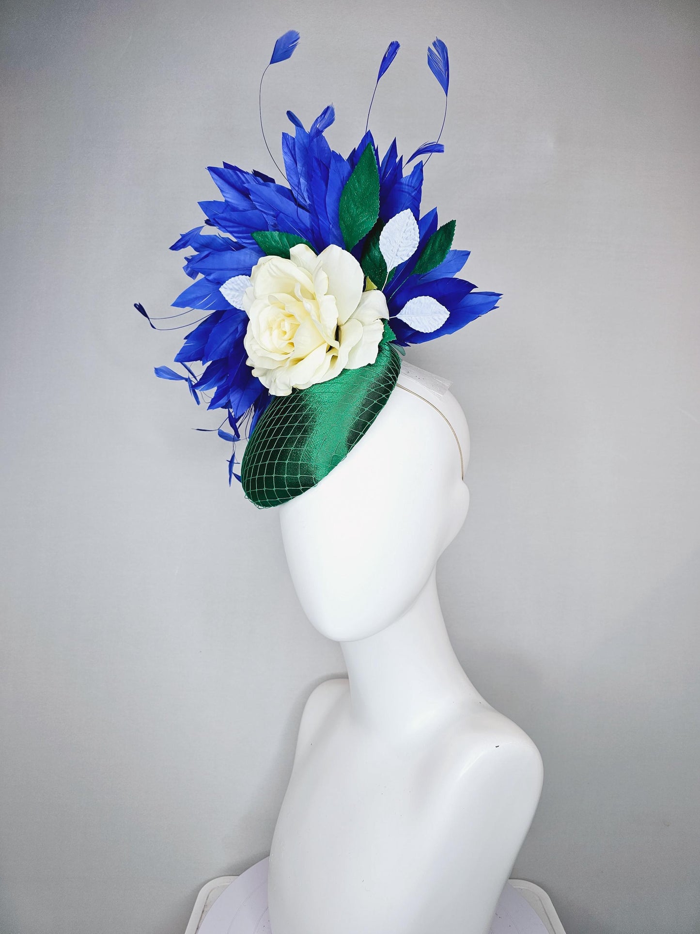 kentucky derby hat fascinator green satin with netting,white ivory satin rose flower,green leaves,royal cobalt blue branching feathers