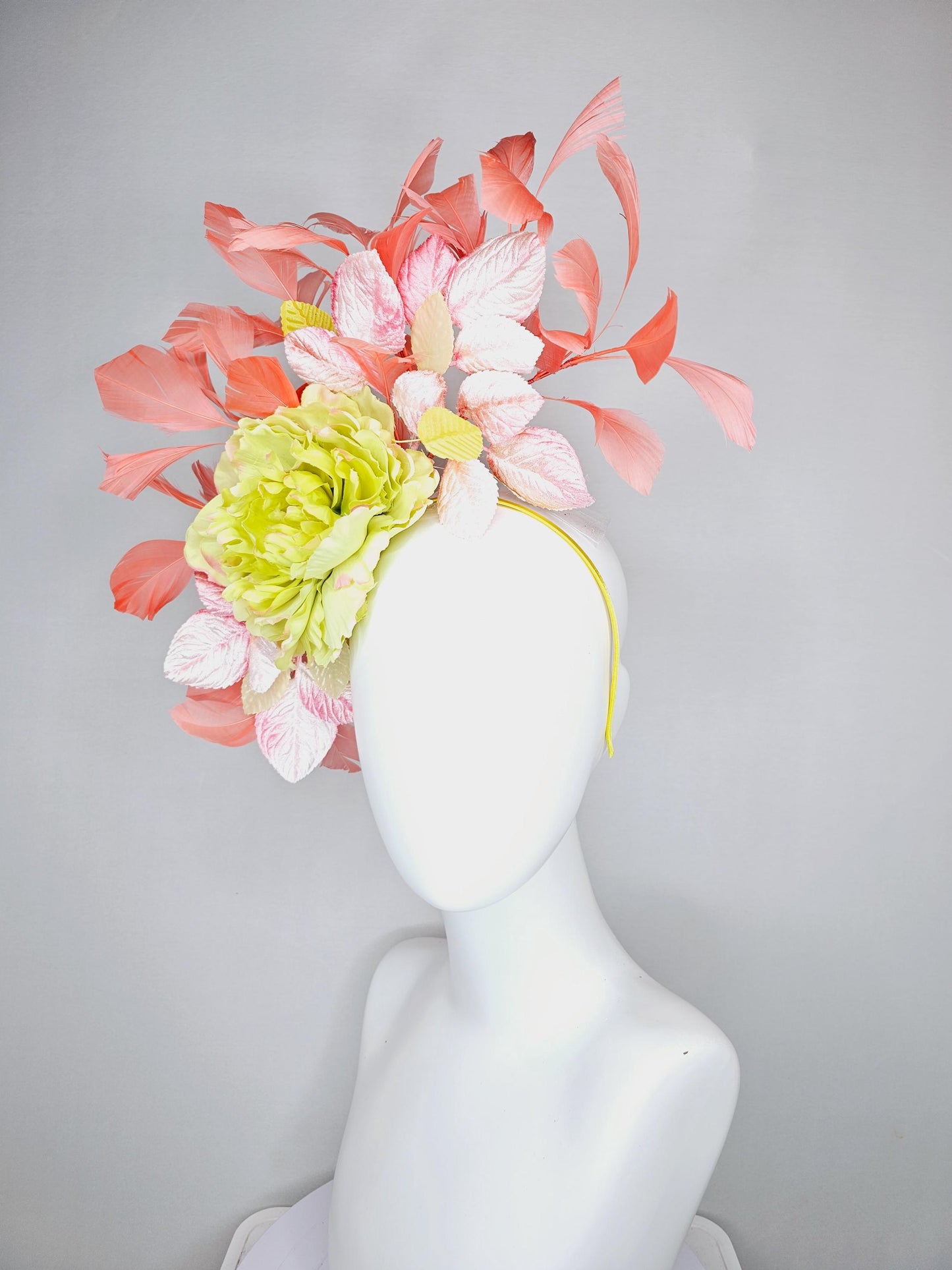 kentucky derby hat fascinator with yellow satin silk flower and light blush pink leaves, orange coral feathers on thin headband