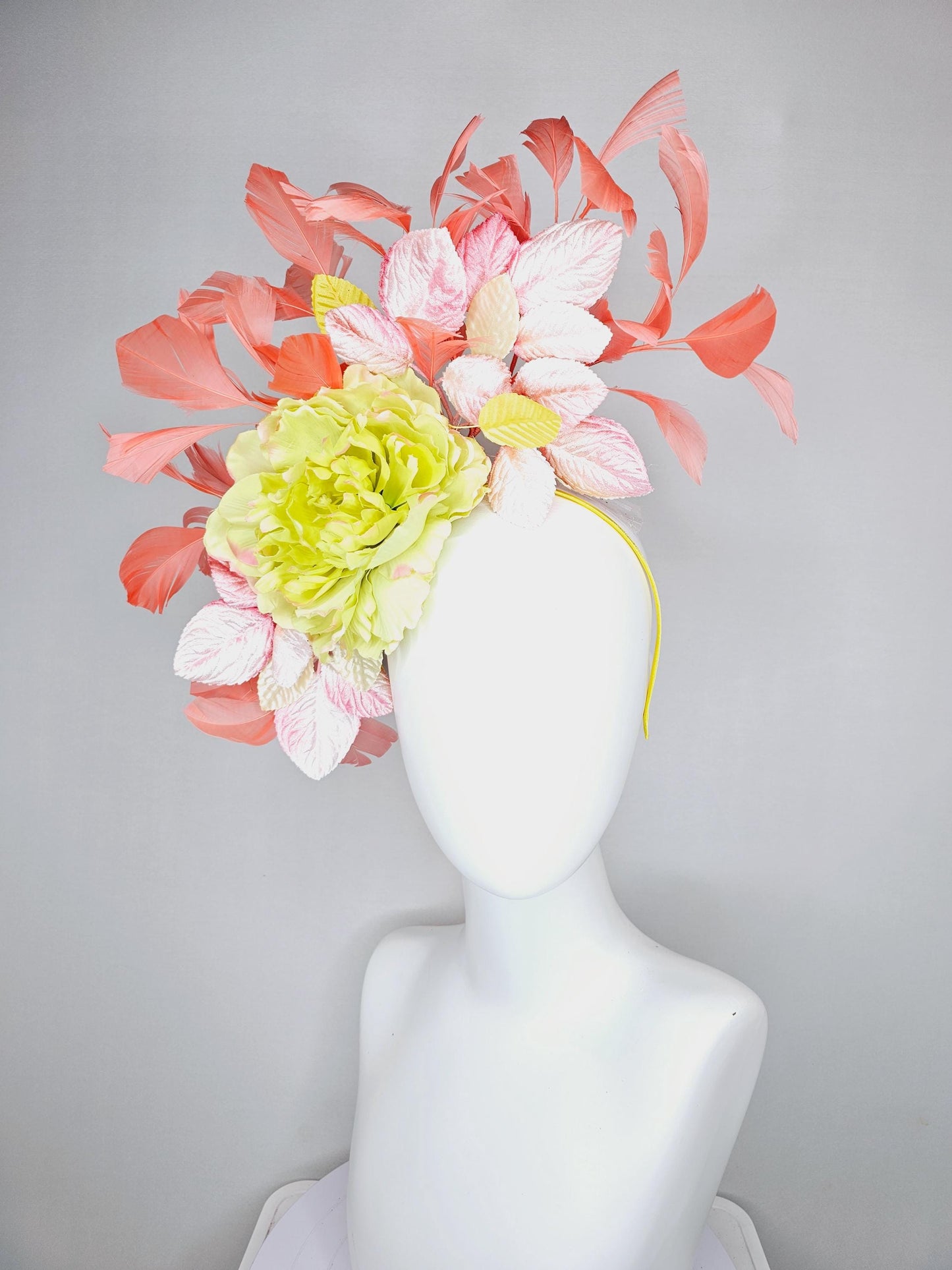 kentucky derby hat fascinator with yellow satin silk flower and light blush pink leaves, orange coral feathers on thin headband