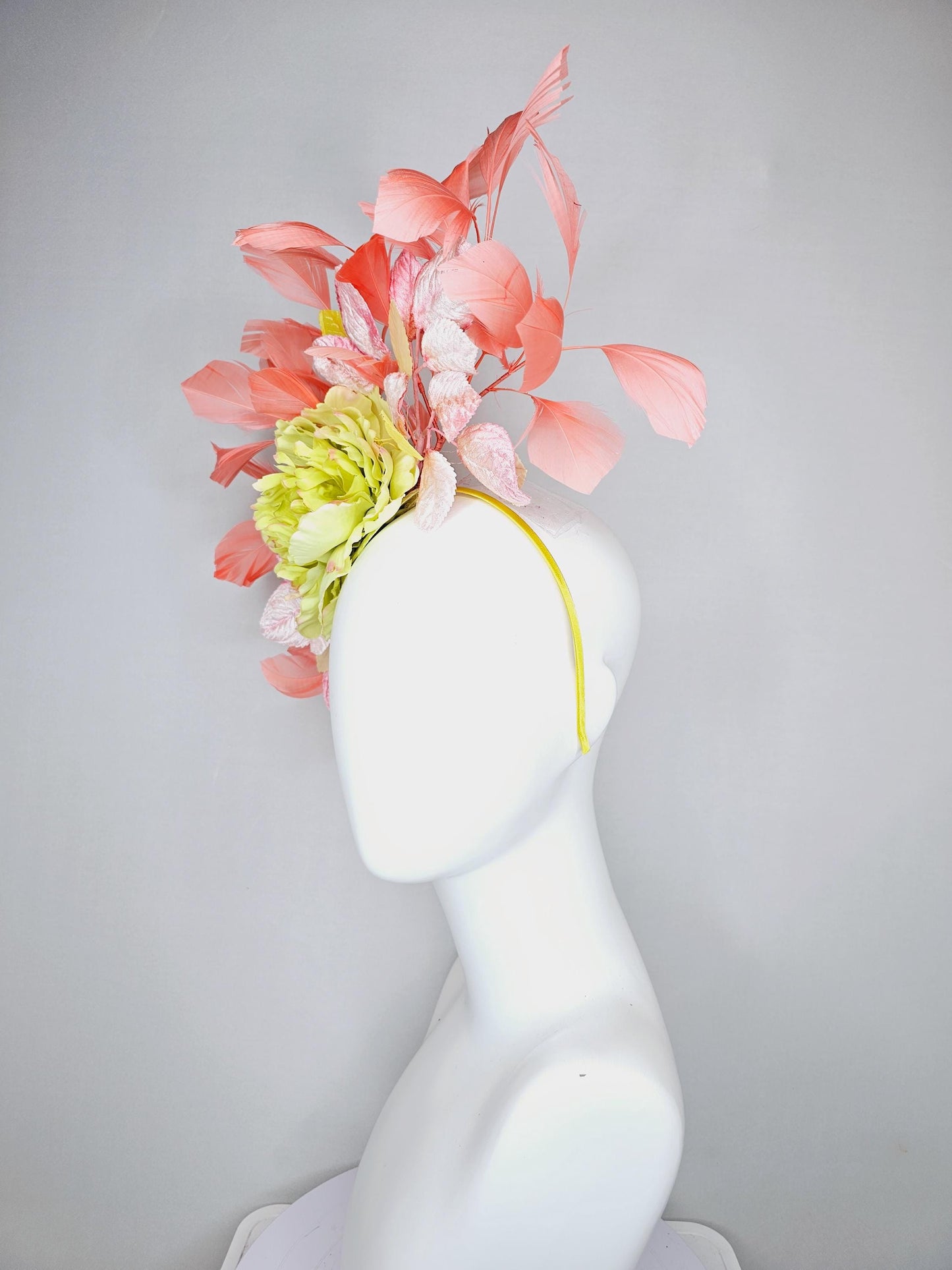 kentucky derby hat fascinator with yellow satin silk flower and light blush pink leaves, orange coral feathers on thin headband