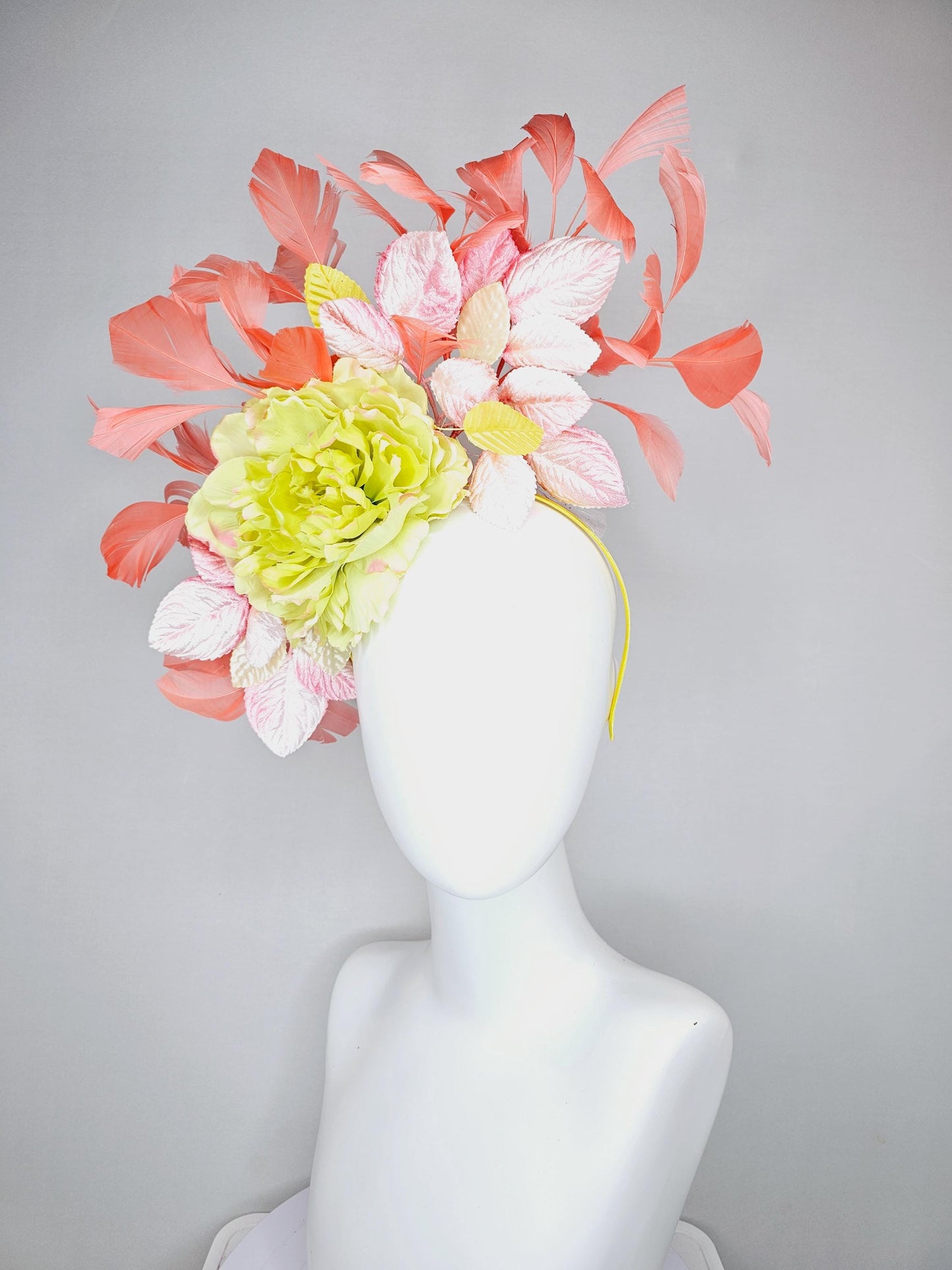 kentucky derby hat fascinator with yellow satin silk flower and light blush pink leaves, orange coral feathers on thin headband